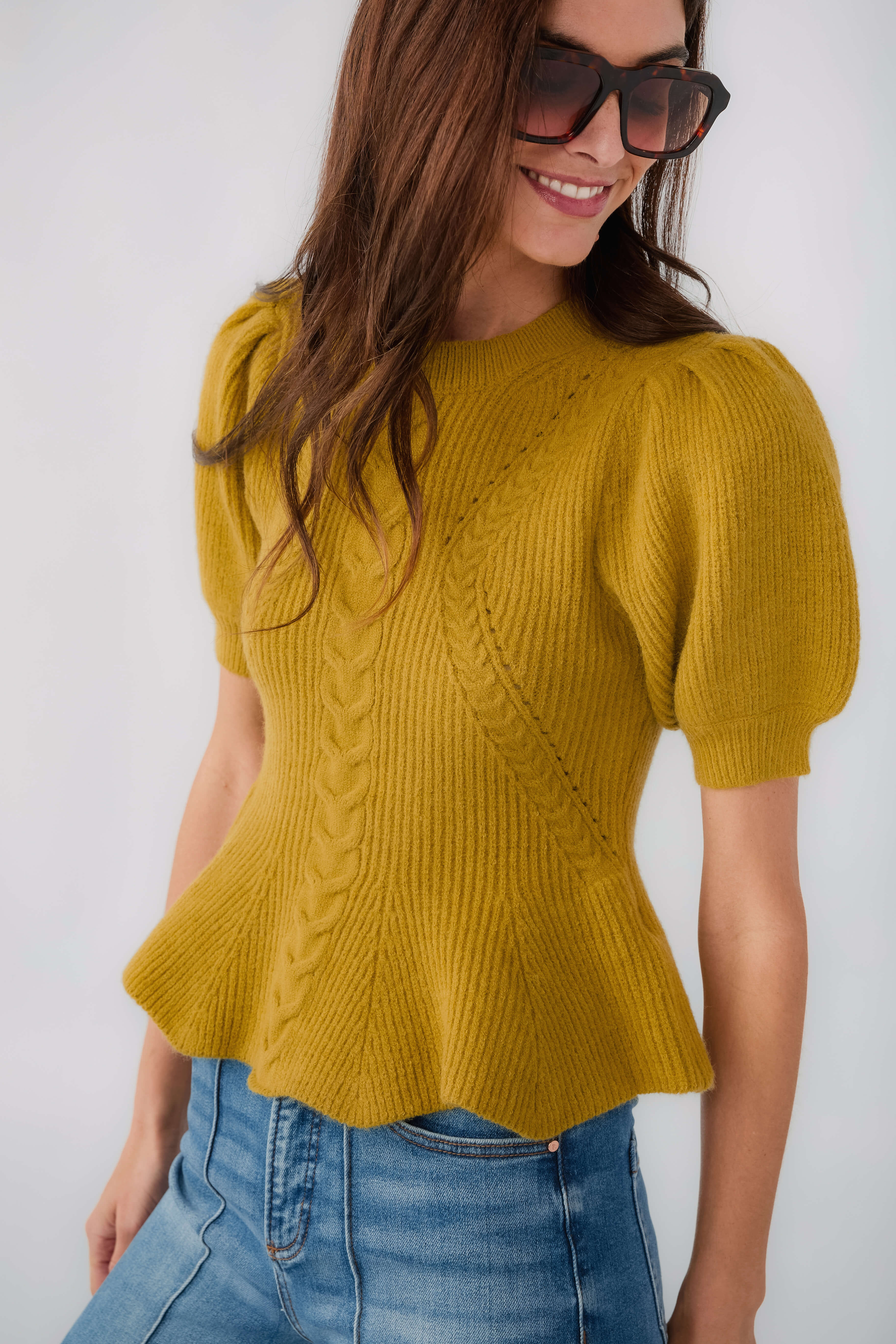 Chartreuse knit top with puff sleeves and textured cable pattern, flared hem