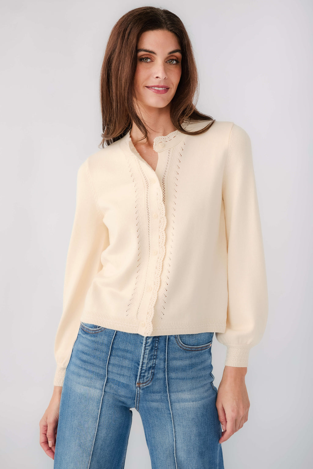 Cream eyelet cardigan with button front and scalloped placket detail, long sleeves