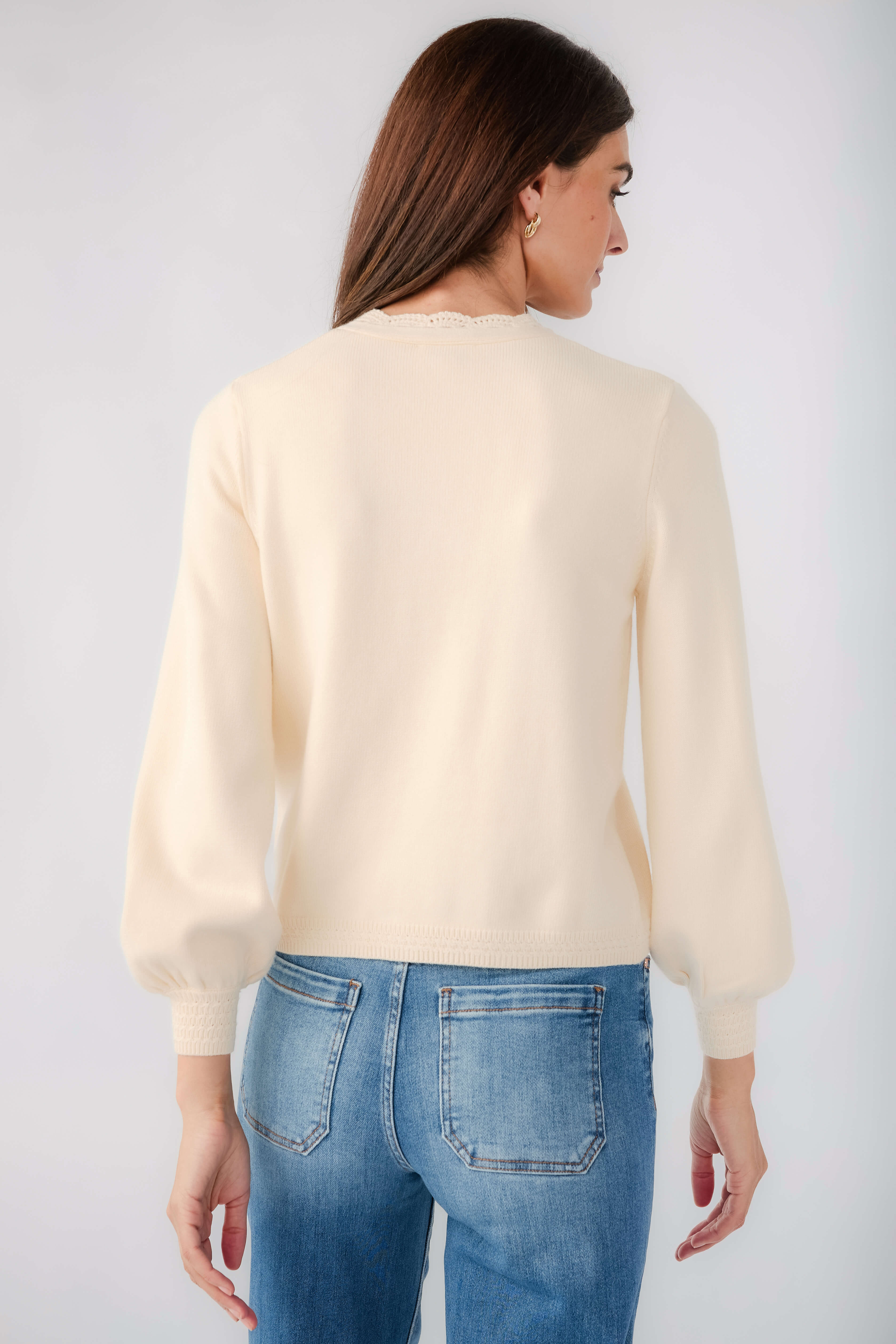 Cream cardigan back view with long sleeves and ribbed cuffs