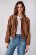 Brown floral jacquard jacket with elastic cuffs and front opening, worn with jeans