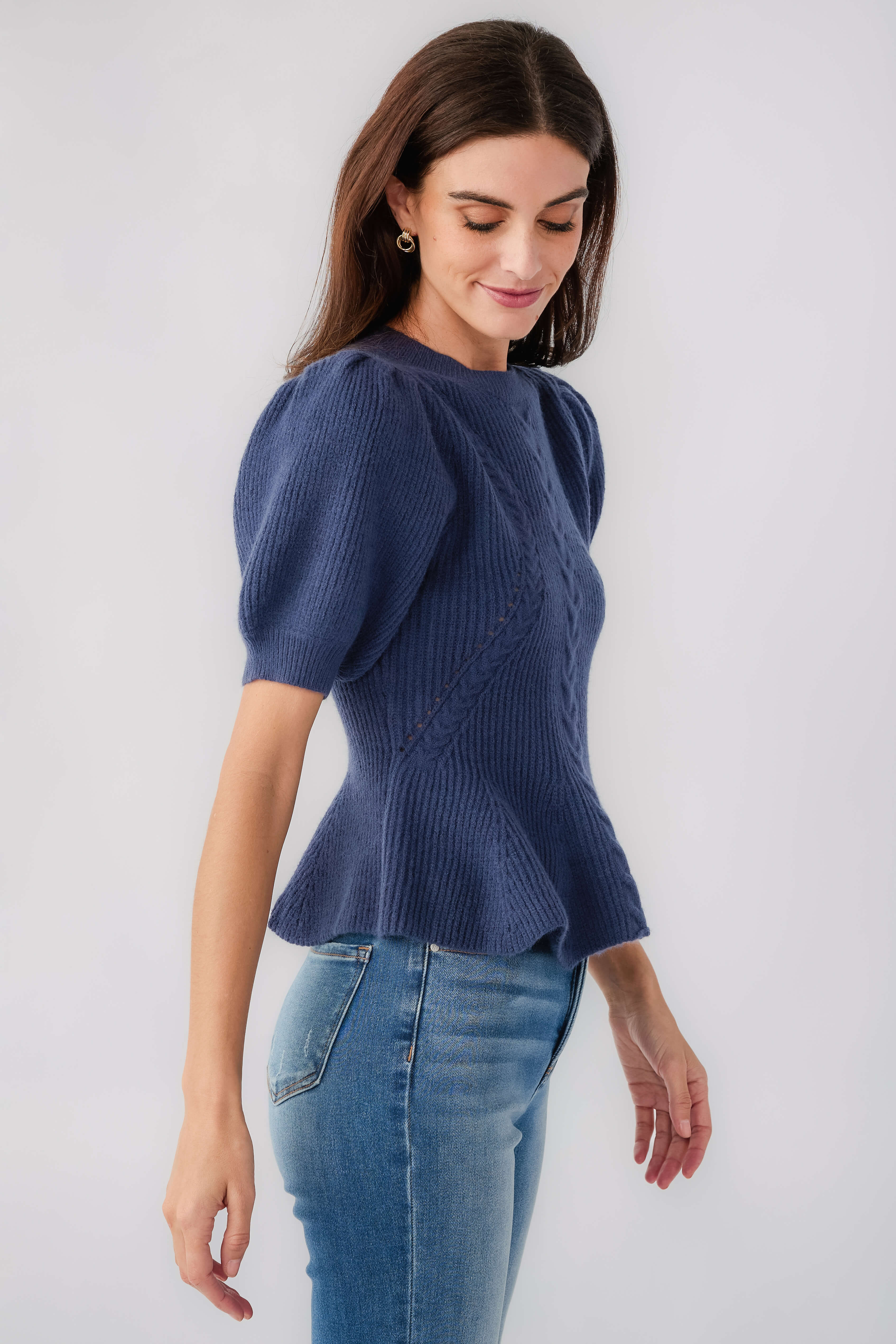 Navy knit top with puff sleeves and crew neck, ribbed textured knit