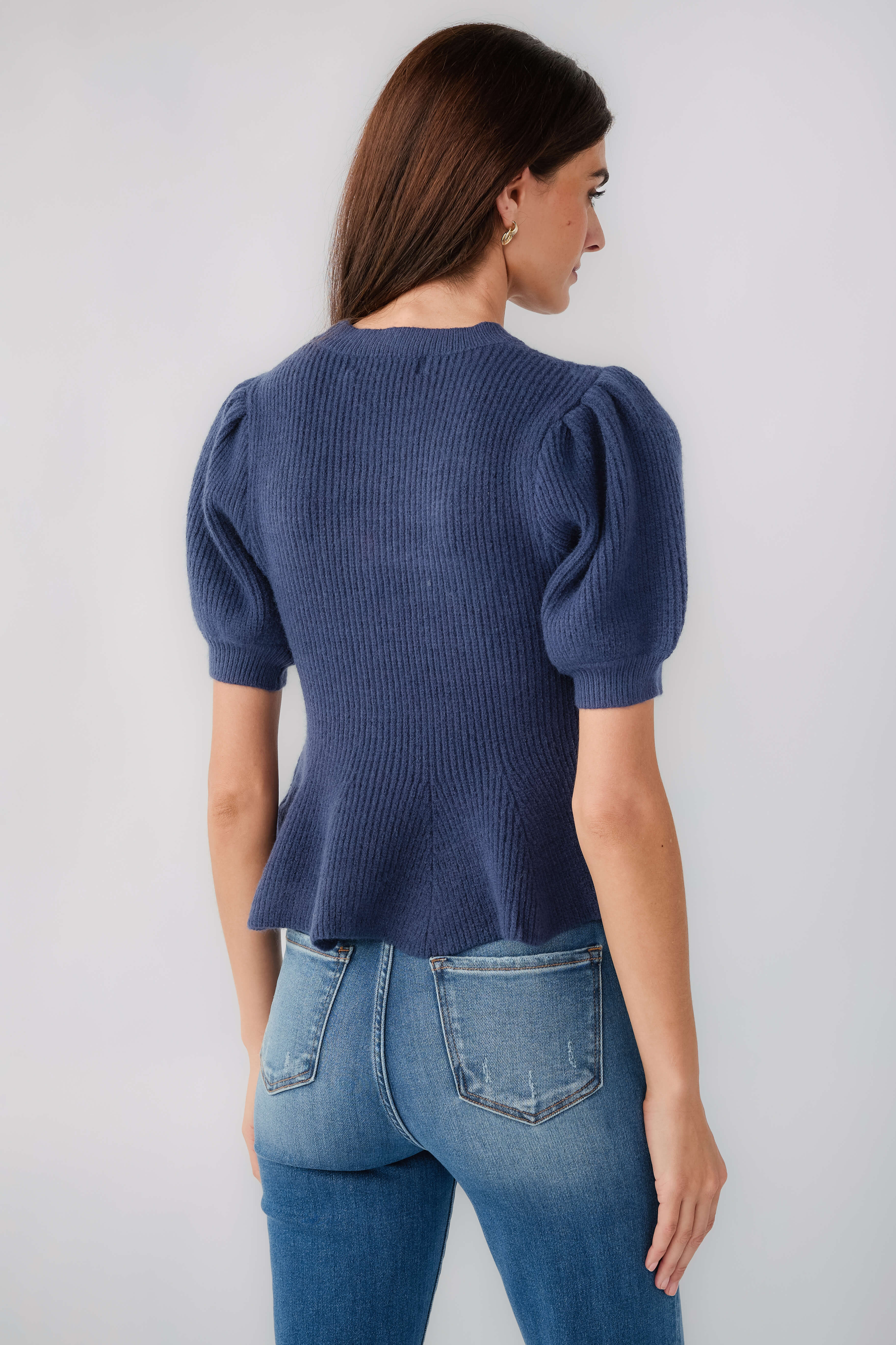 Navy knit top with back puff sleeves and ribbed crew neck, flared hem