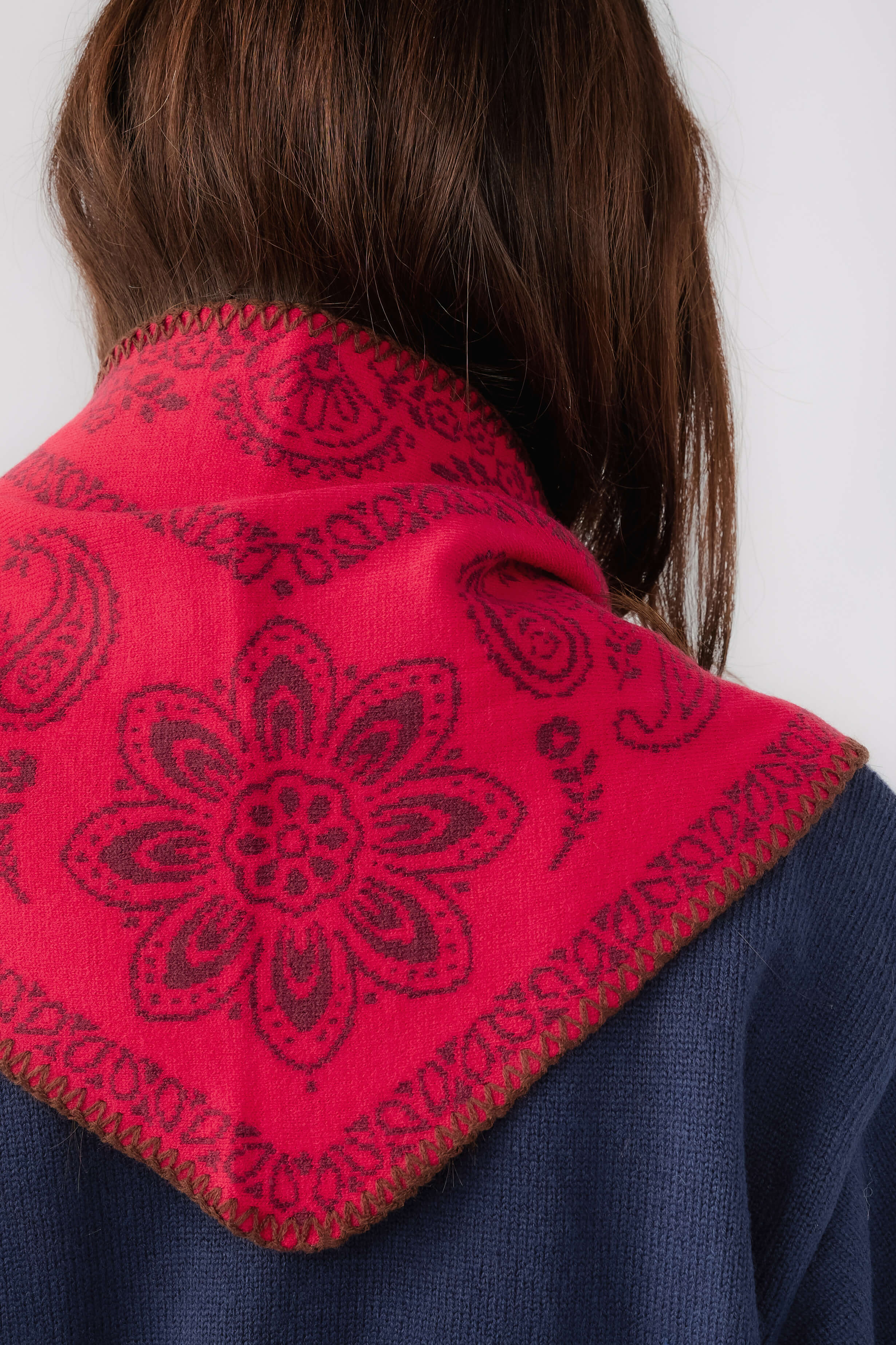 Free People knitted triangle scarf back, vivid red paisley fabric panel