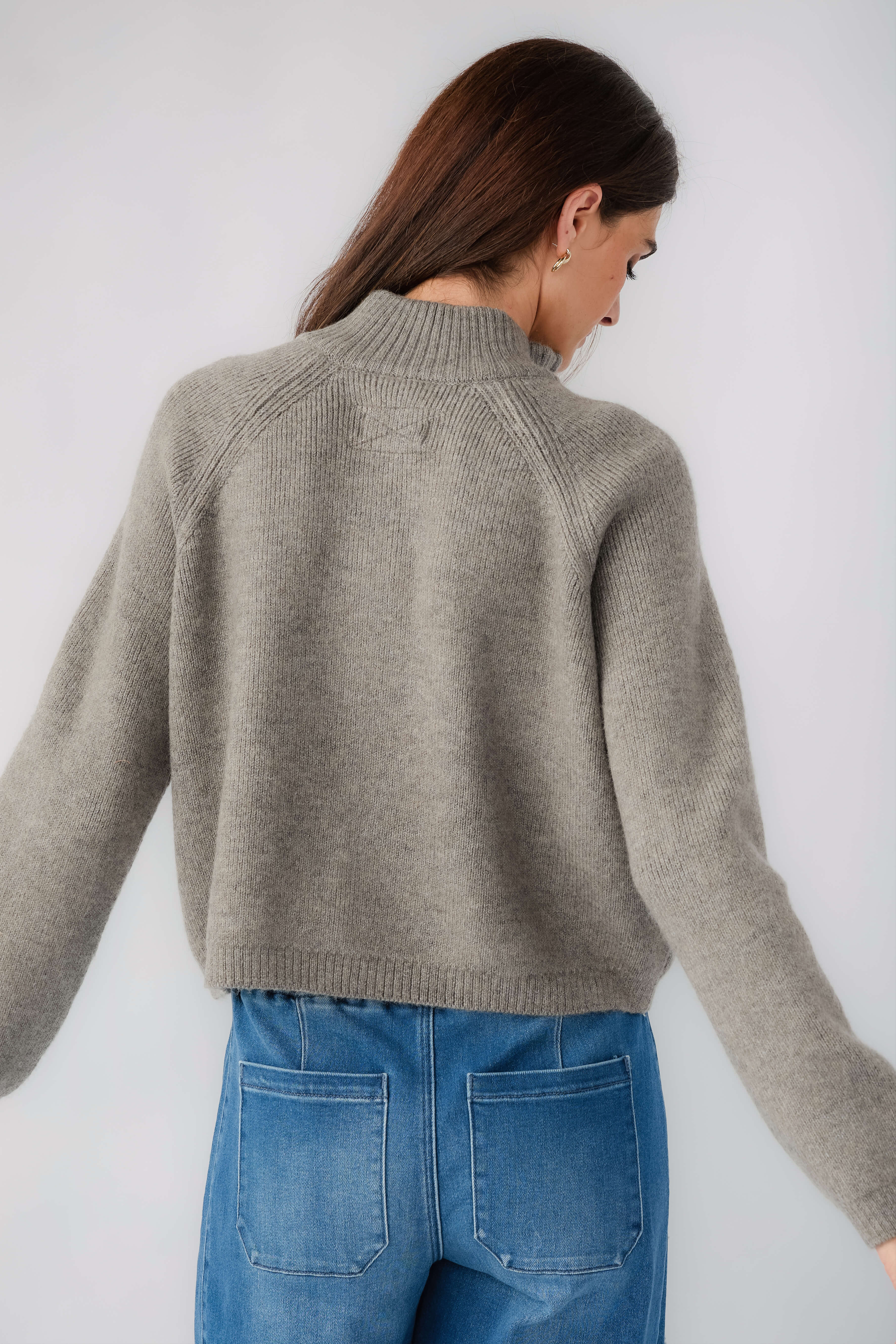 Cool grey half-zip knit sweater, back view with ribbed neckline