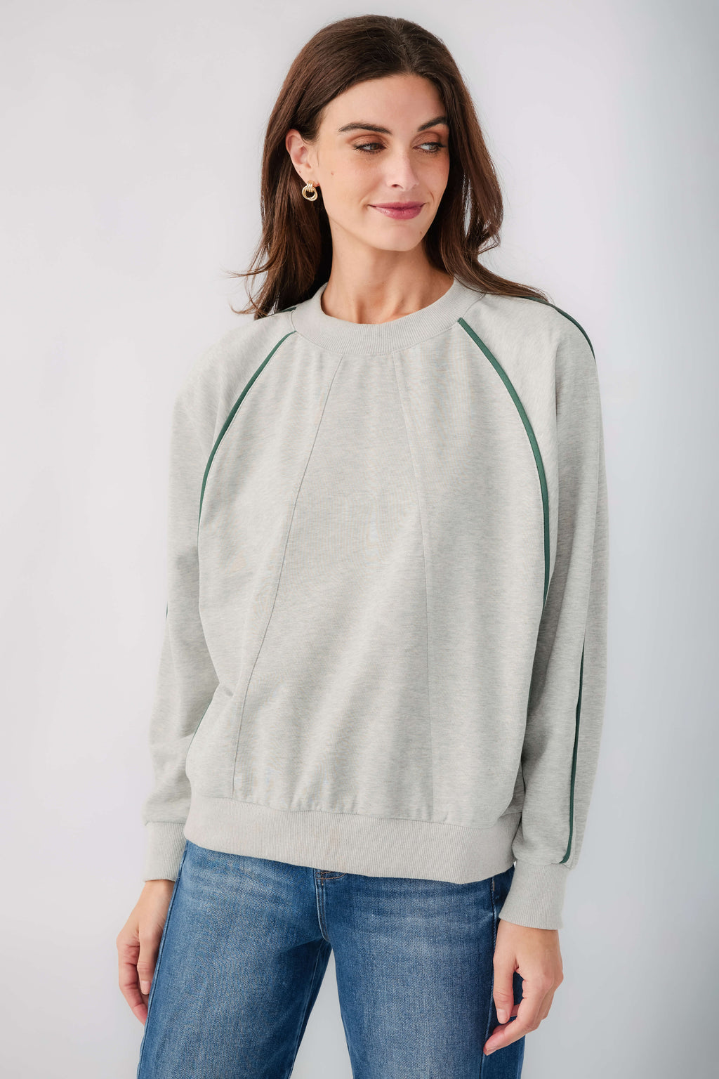 Front view: heather grey raglan sweatshirt with contrast green piping trim at seams