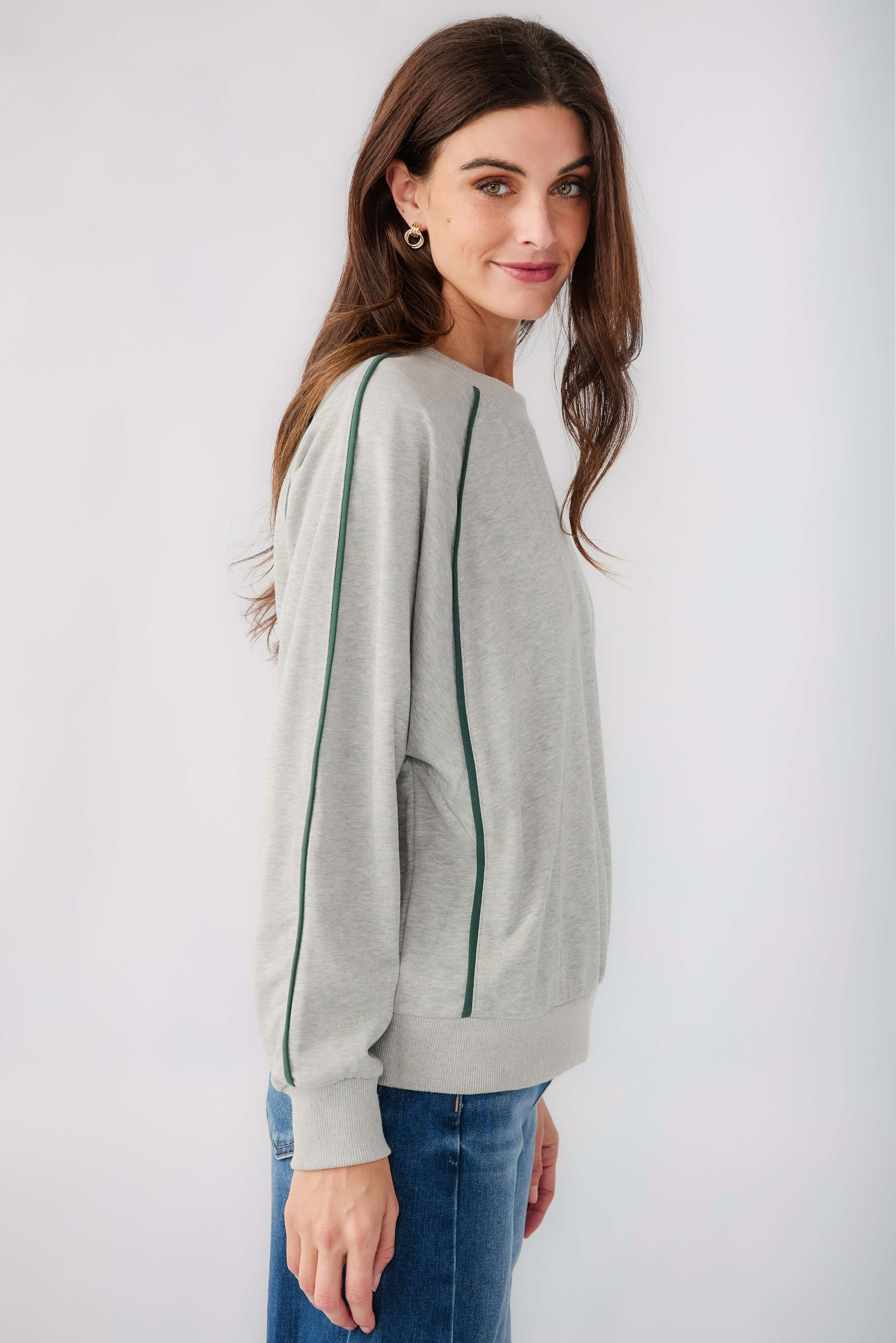 Heather grey raglan sleeve sweatshirt with contrast green piping and crew neckline
