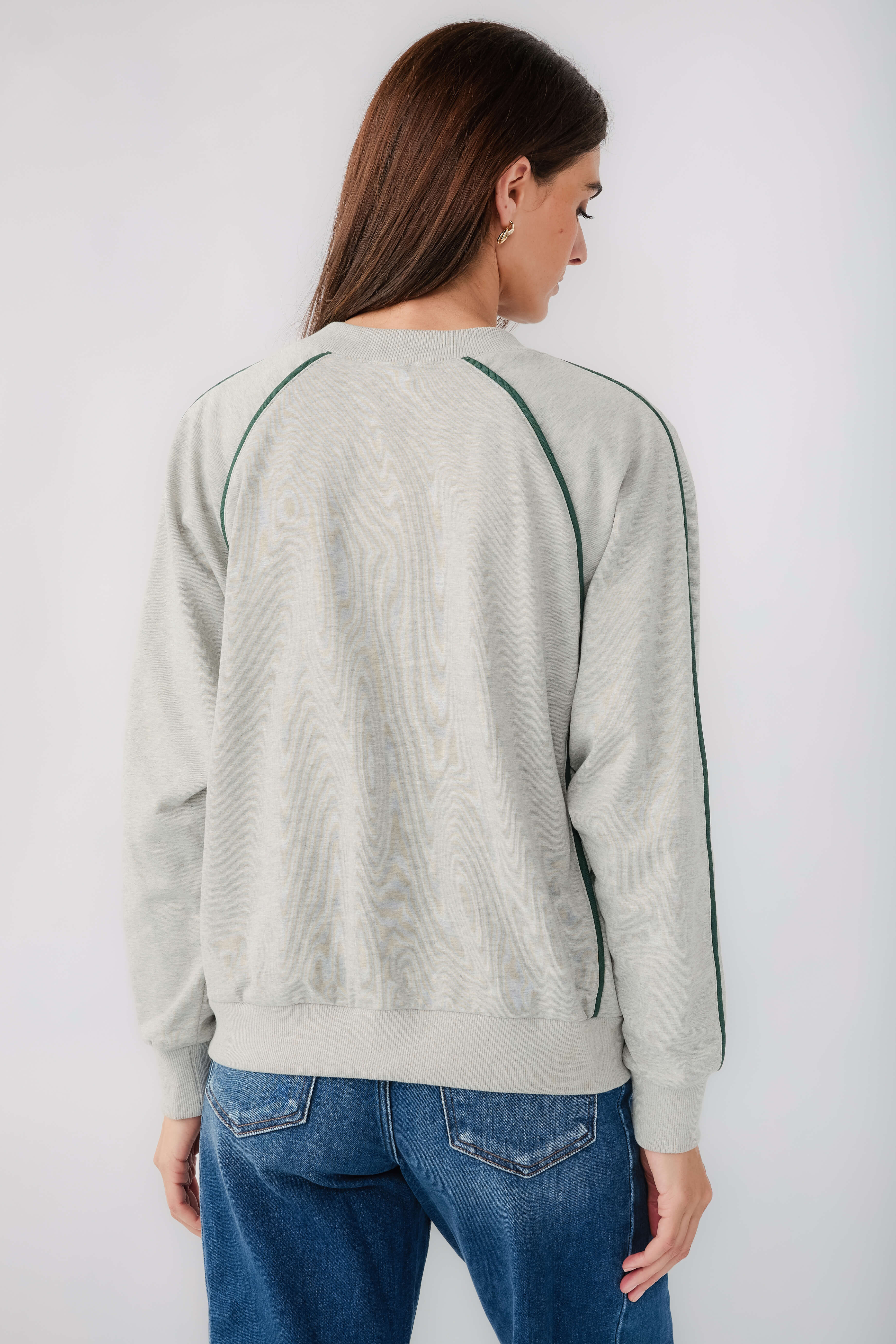 Back view: heather grey raglan sweatshirt with contrast green piping seams