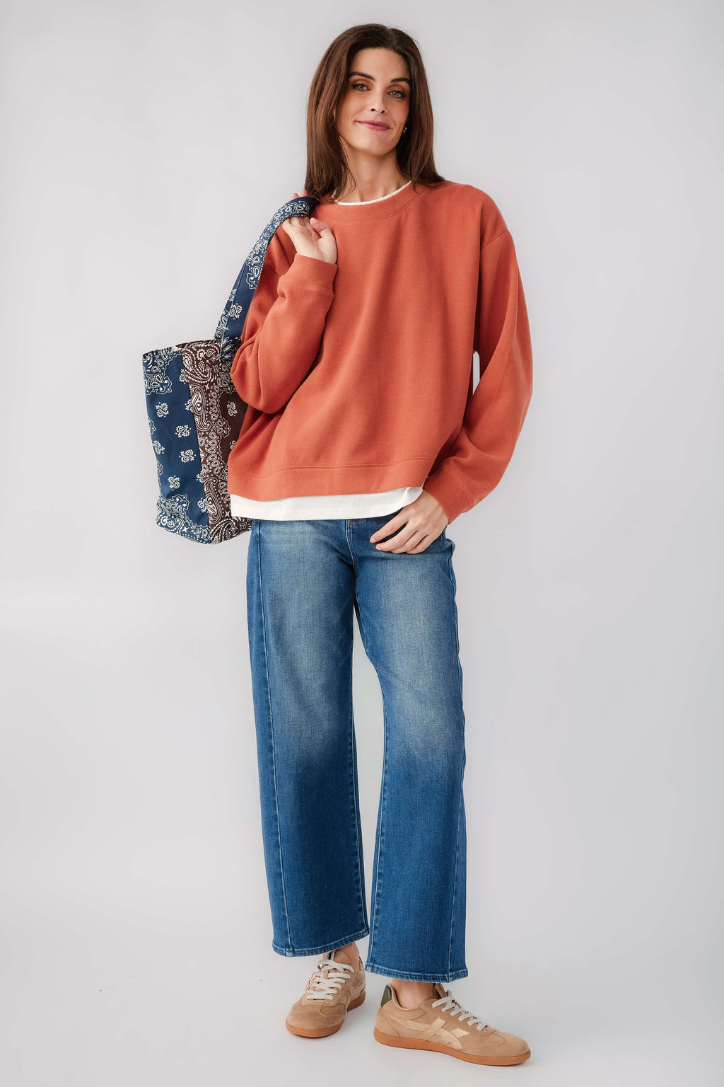 Rust crewneck pullover with long sleeves and white hem band