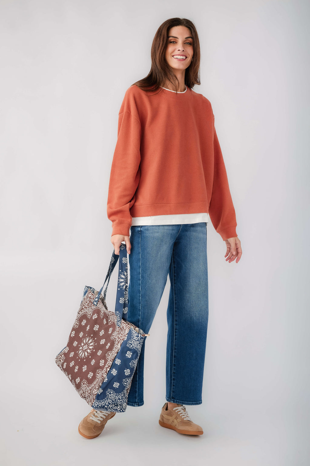 Rust crewneck pullover front view with long sleeves and white hem band