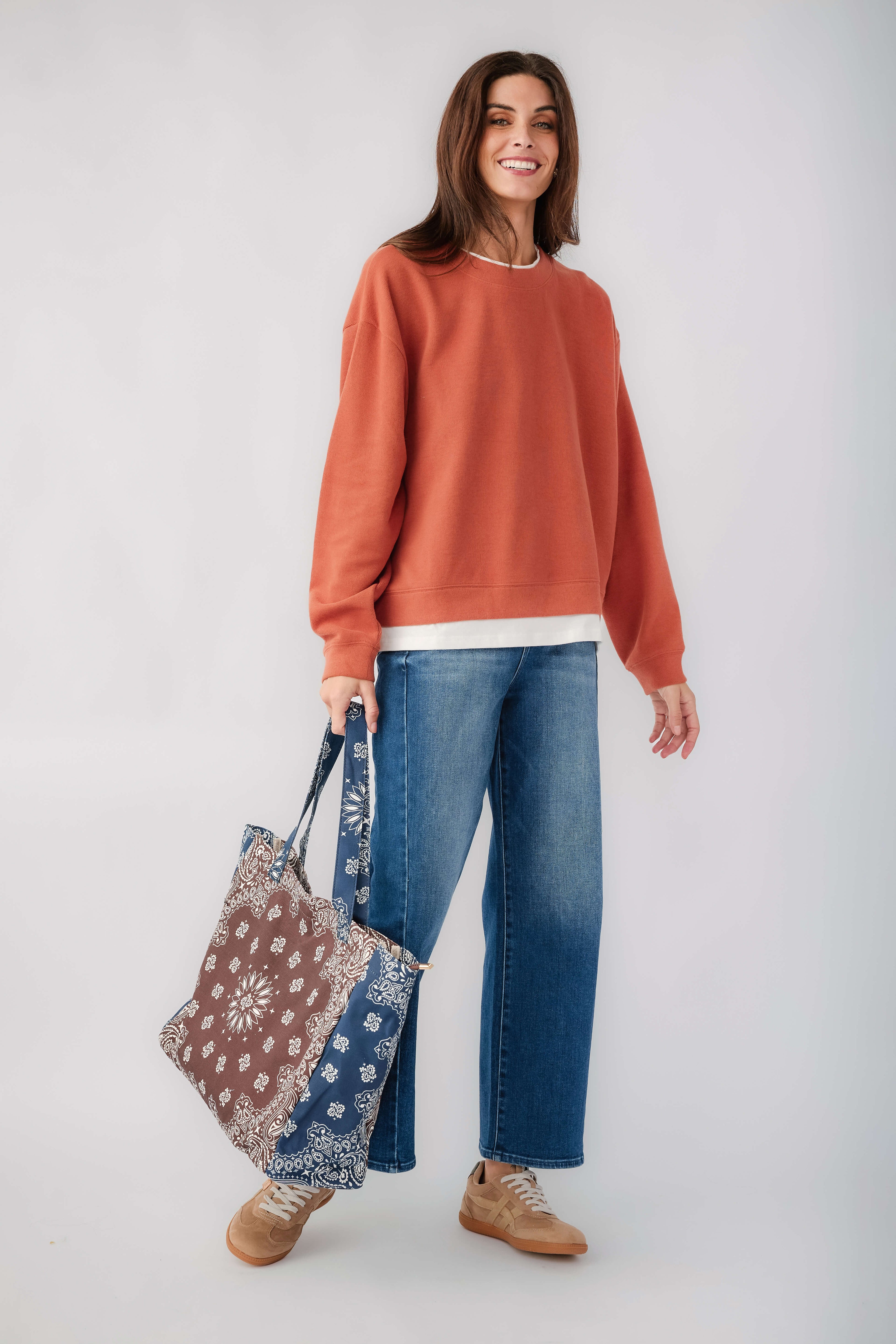 Rust crewneck pullover front view with long sleeves and white hem band