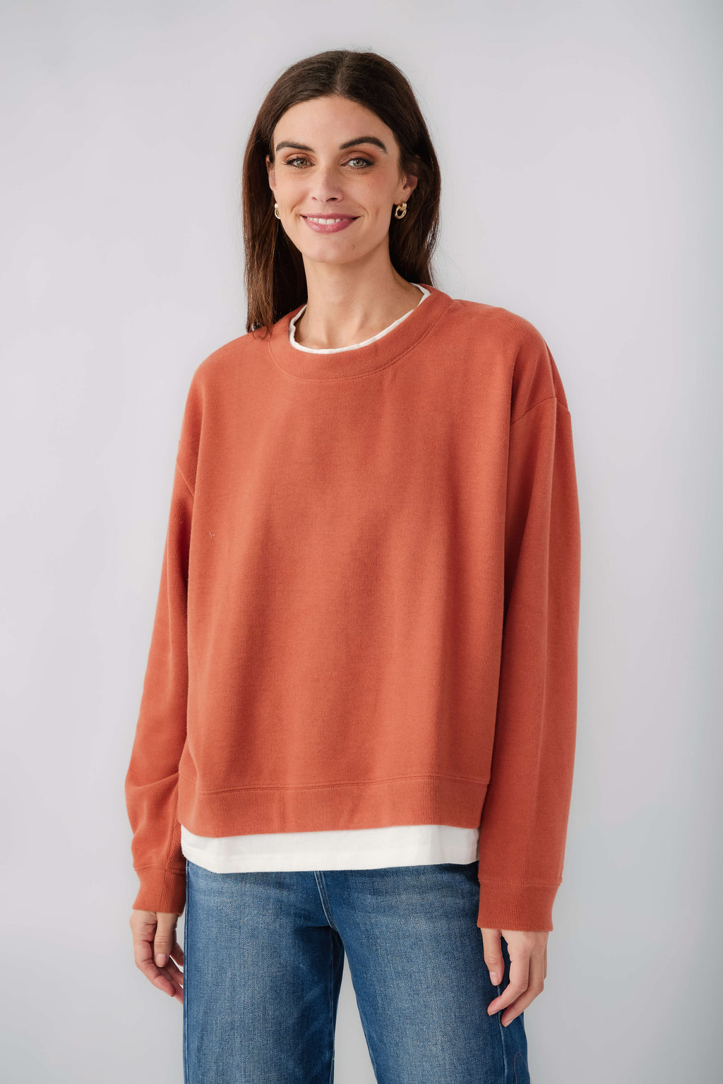 Rust crewneck pullover close front view with white hem band