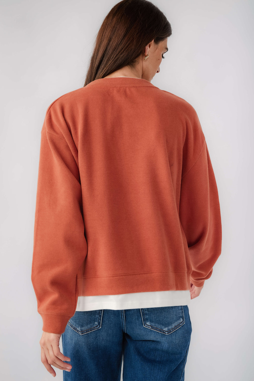 Rust crewneck pullover back view with long sleeves and white hem band