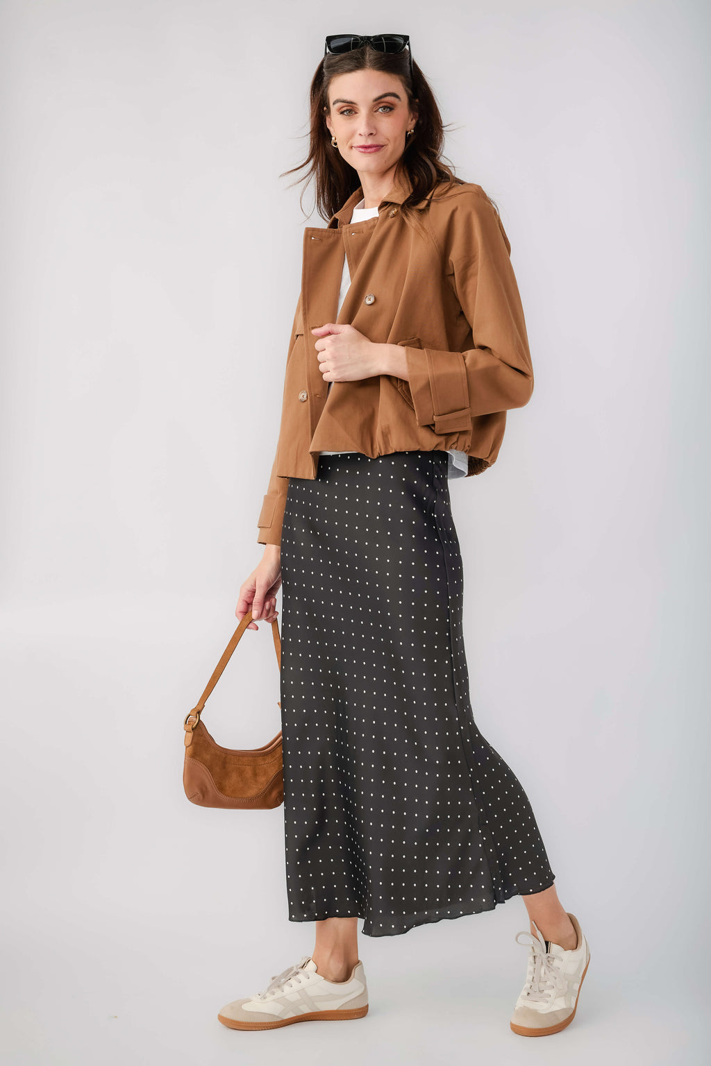 Black satin midi skirt with small white polka dots, front view