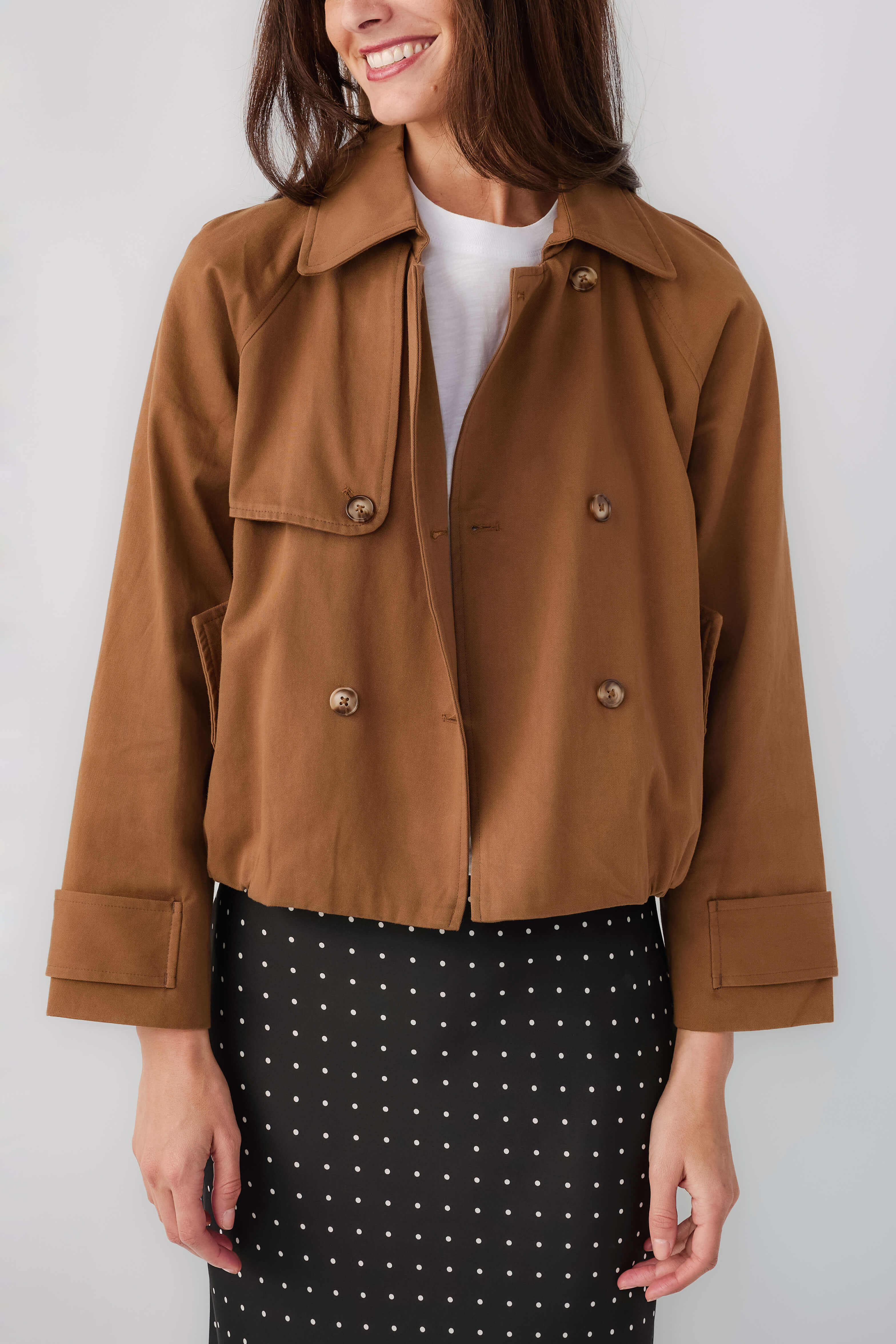 Brown cropped trench jacket with point collar, double-breasted buttons, flap pockets