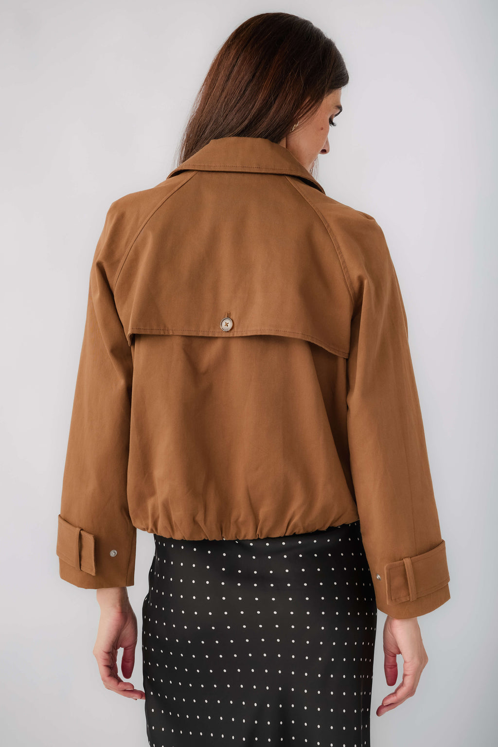 Back view of brown cropped trench jacket with yoke and buttoned collar