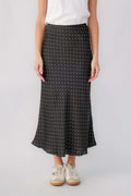 Black satin midi skirt with small white polka dots and flowy hem