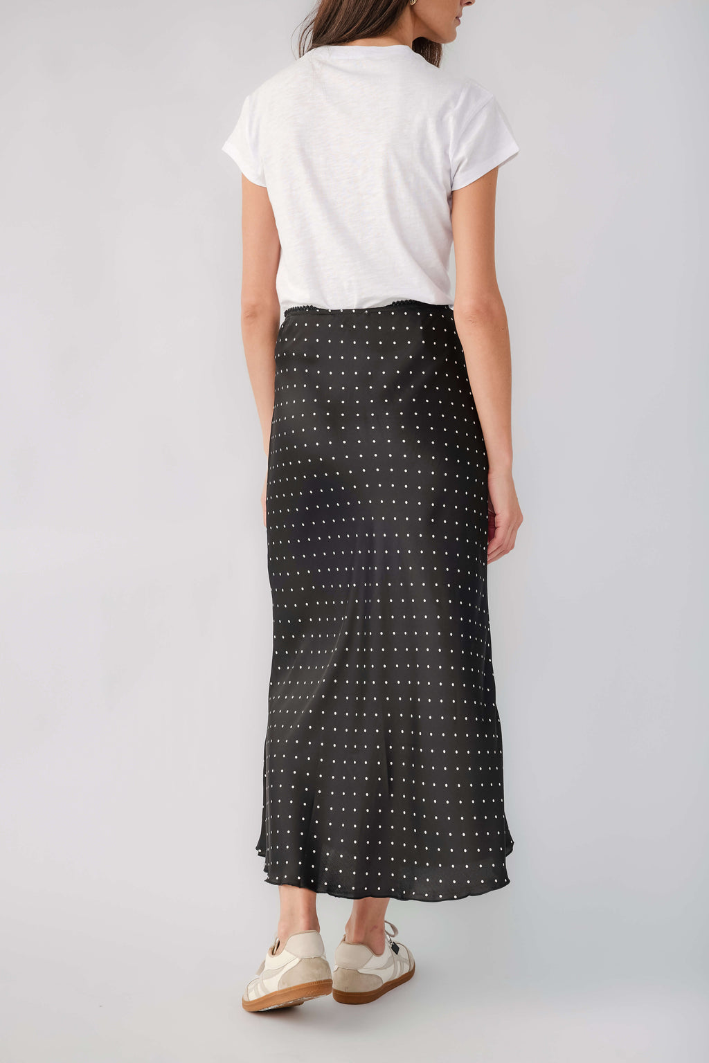 Black satin midi skirt with white polka dots, back view