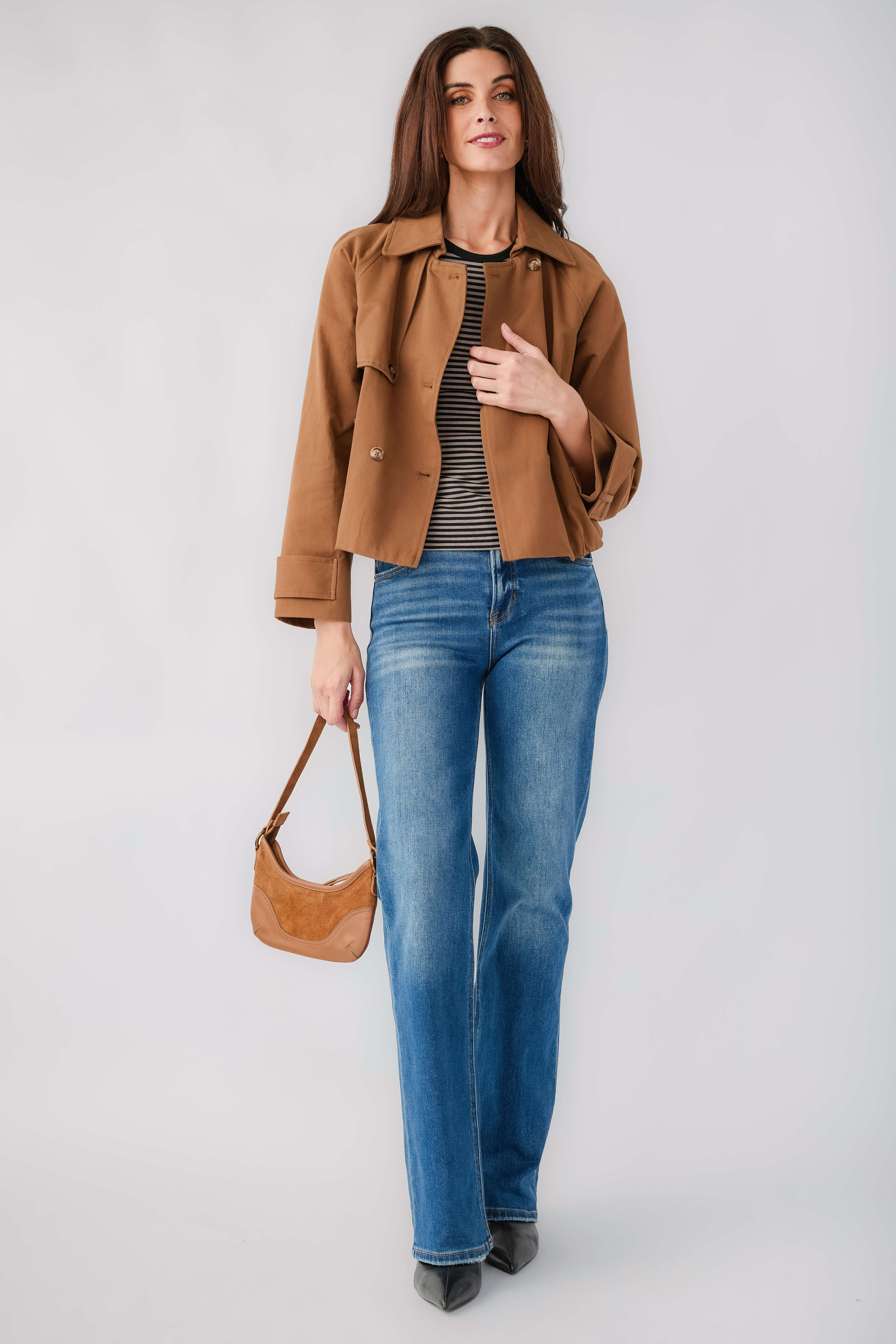 Brown cropped trench jacket with point collar and flap pockets over a striped top