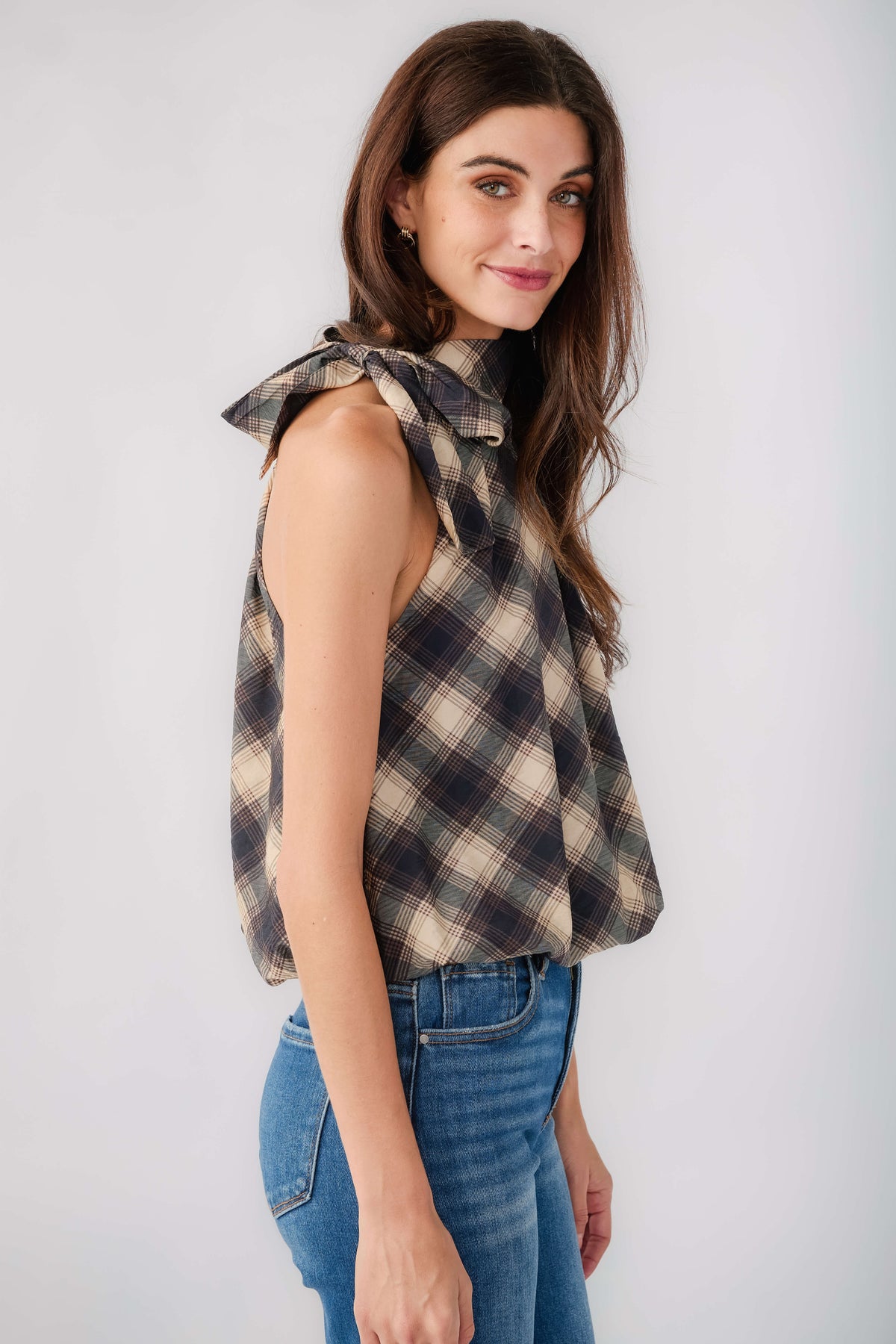 Sleeveless plaid halter top, draped neck tie and fitted bodice