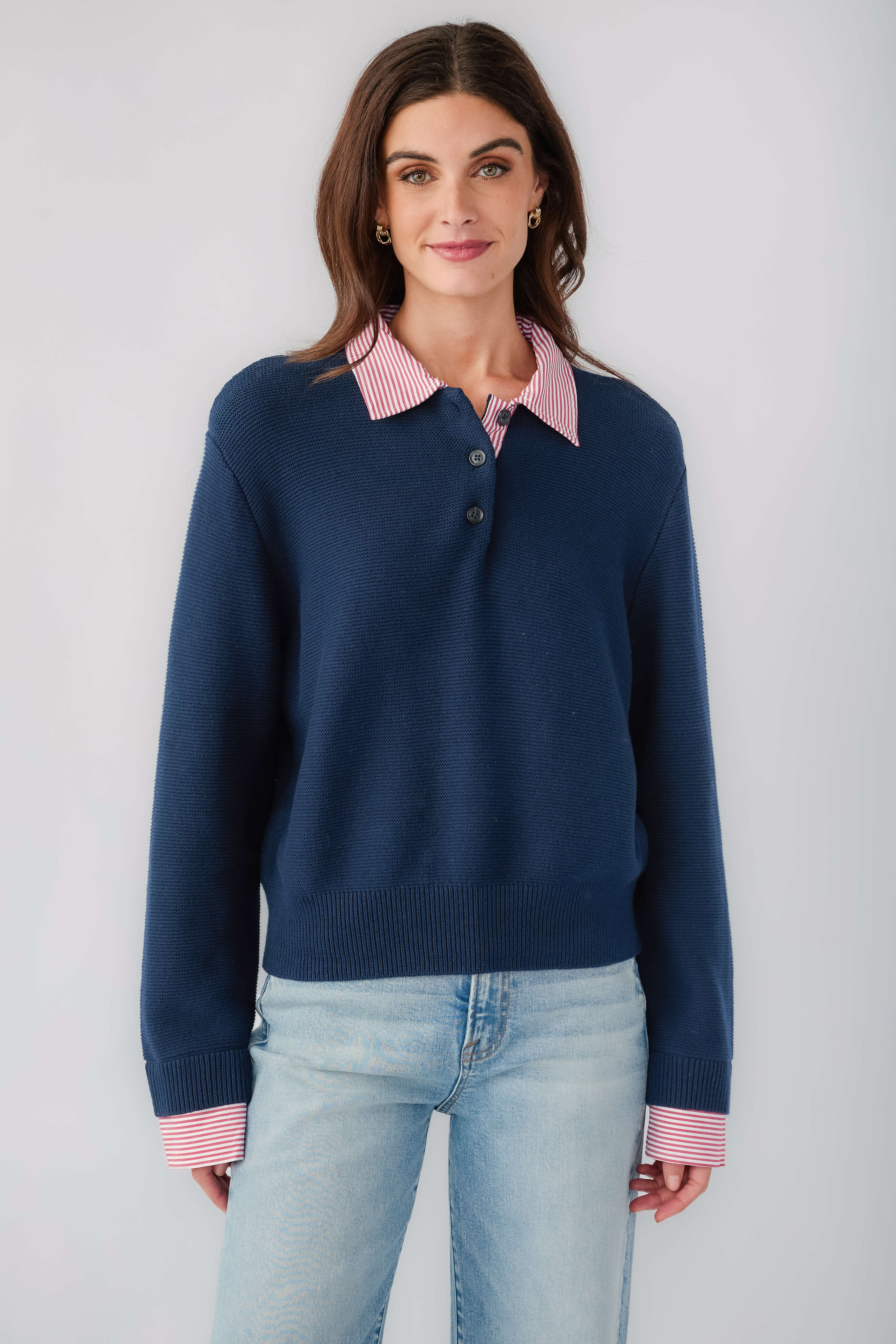 Navy knit sweater with striped pink-red collar and button placket, long sleeves