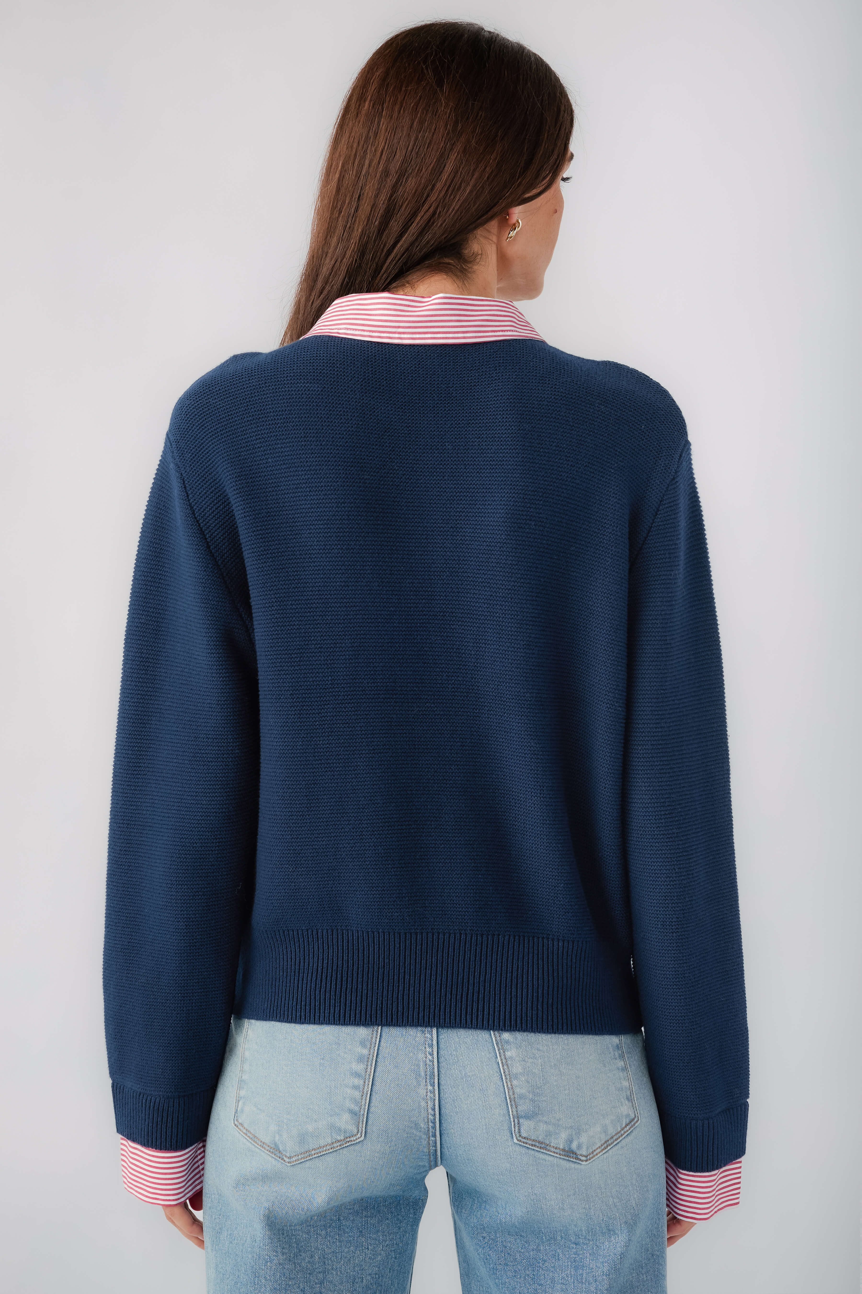 Navy knit sweater back view with striped collar and ribbed cuffs