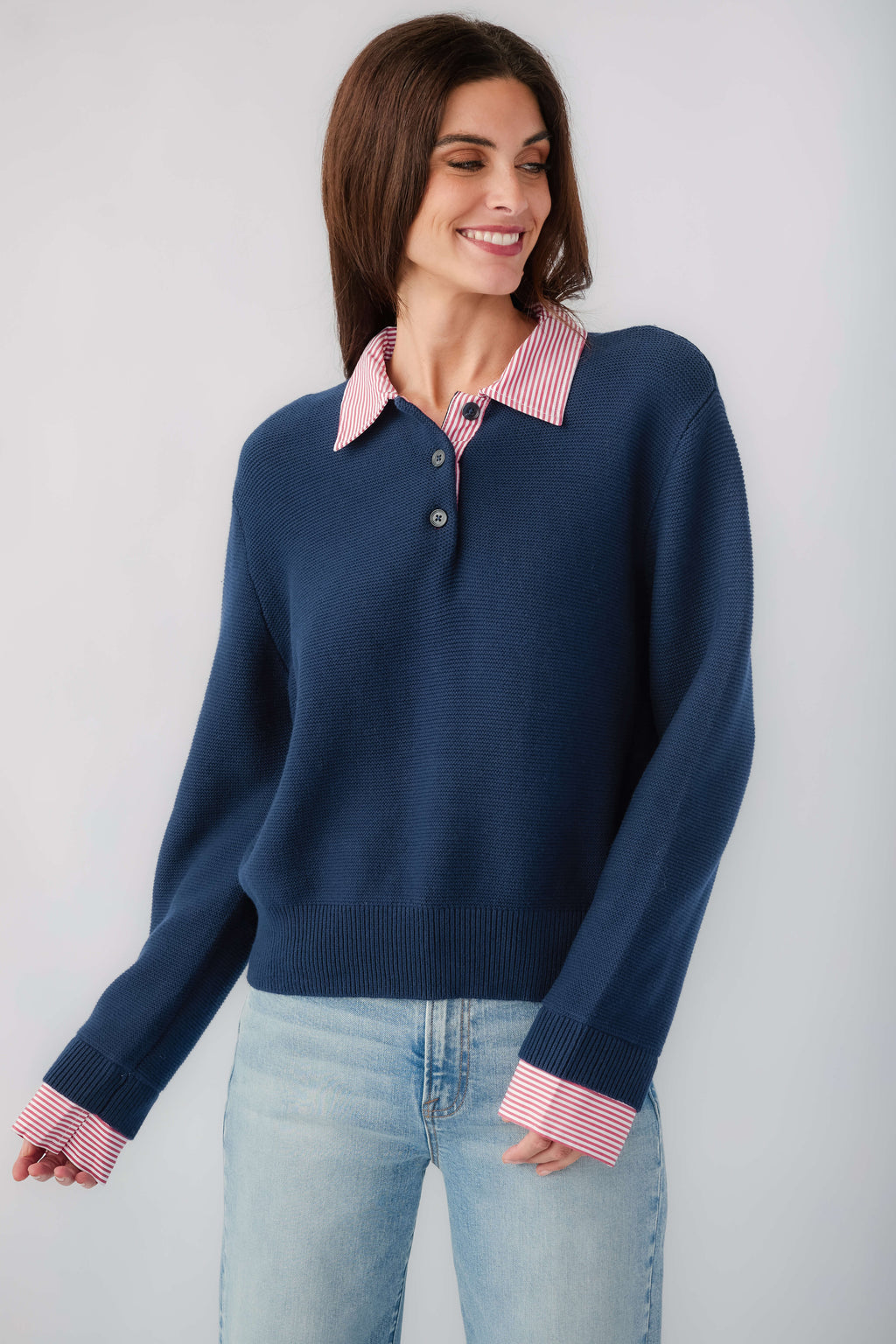 Navy knit sweater with striped pink-red collar and cuffs, long sleeves