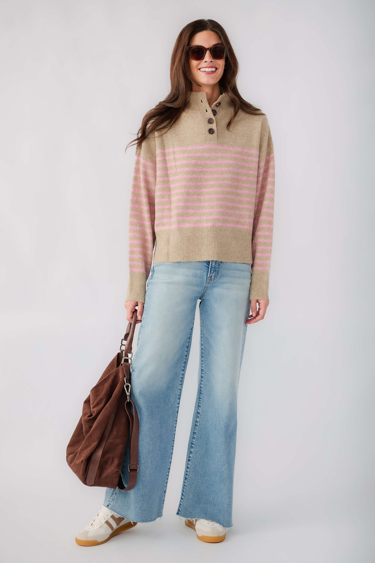 Mocha knit pullover with pink stripe across chest and half-button placket at collar
