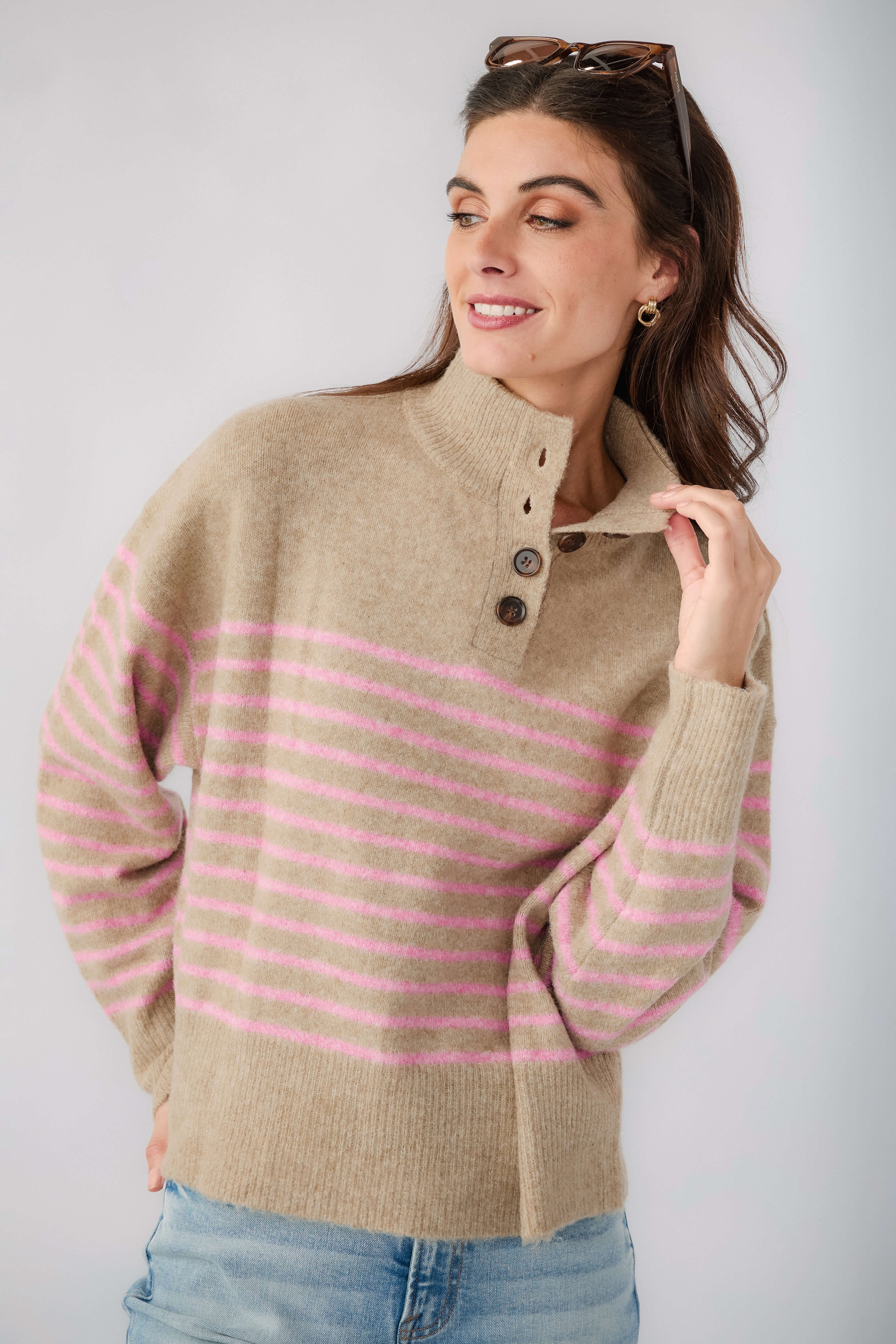 Mocha knit pullover with pink stripes, half-button placket at neckline and ribbed cuffs