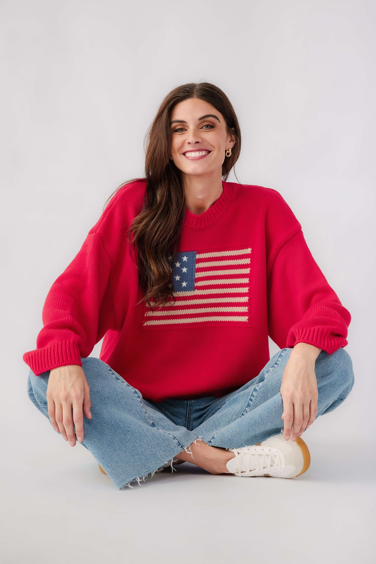 Red crewneck sweater with American flag graphic and wide ribbed knit cuffs