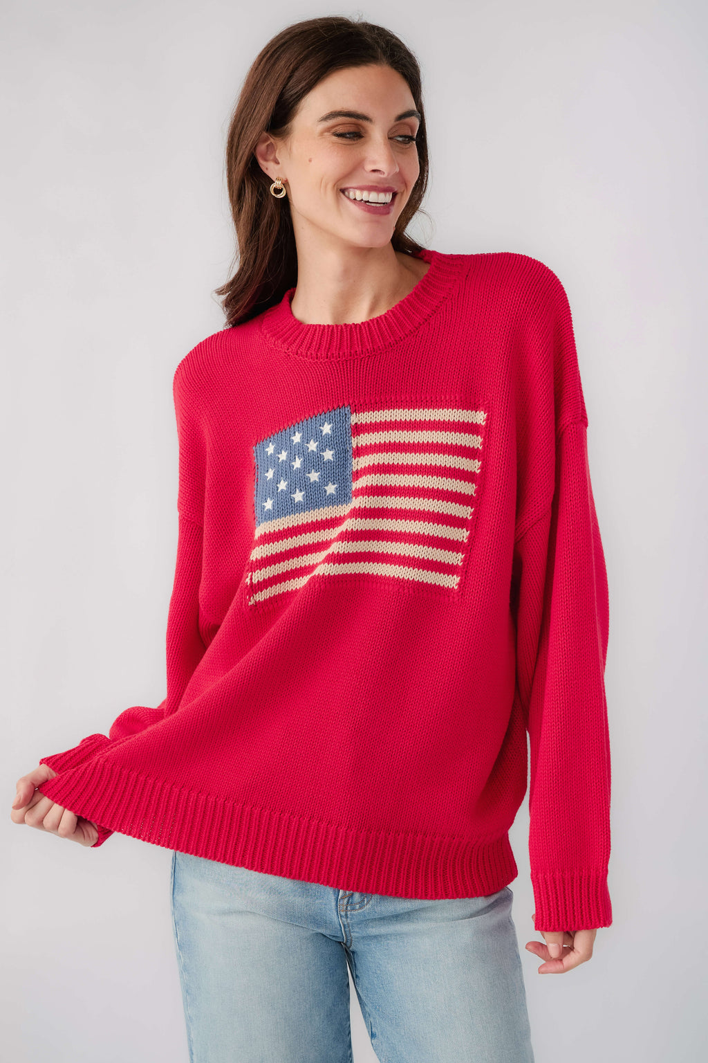 Red crewneck sweater with American flag graphic and ribbed knit hem
