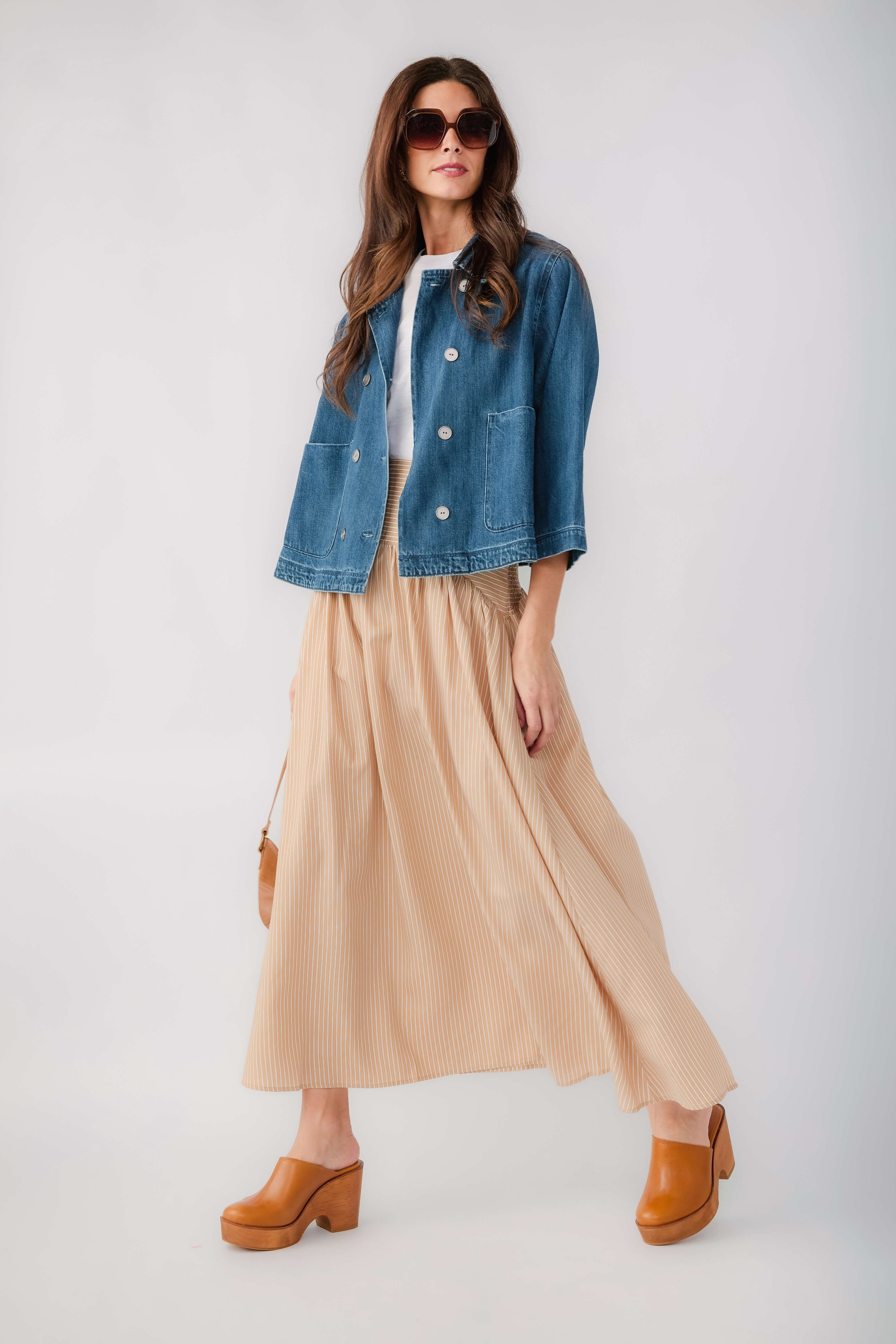 Dark blue cropped denim jacket with metal button front and buttoned flap pockets