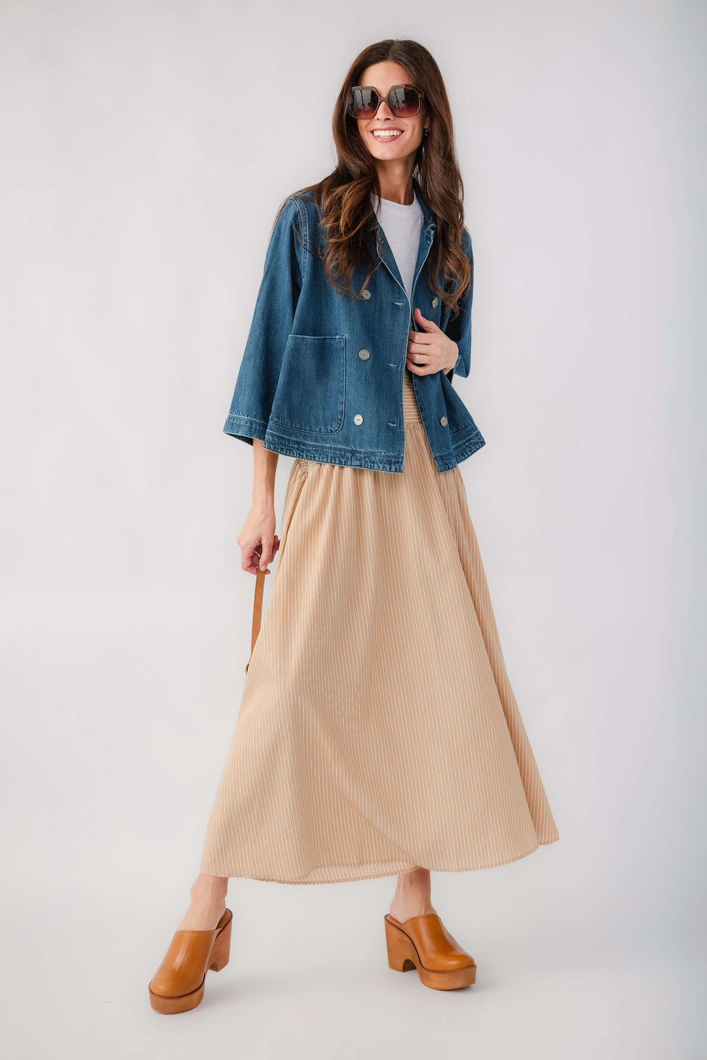 Dark blue cropped denim jacket with relaxed fit and button front, side view