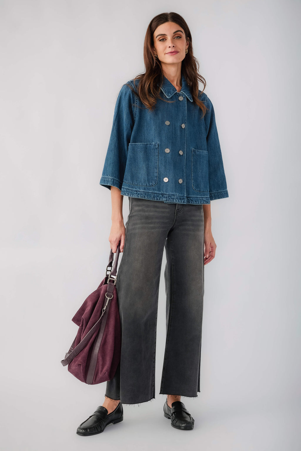 Dark blue cropped denim jacket with double-breasted button front and 3/4 sleeves