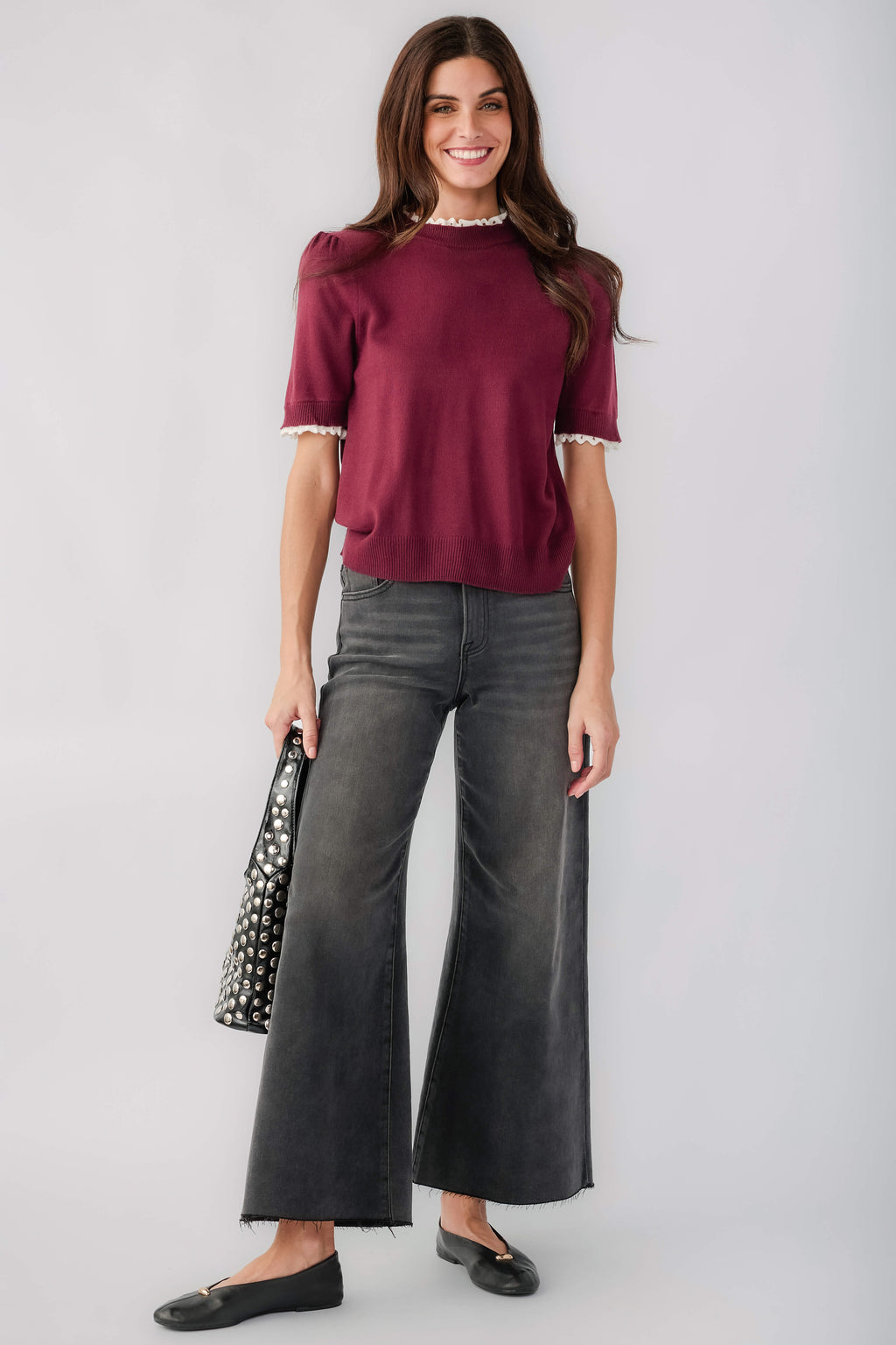 Wine knit top with mock neck and white lace trim at cuffs and hem