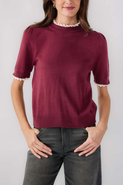 Wine mock-neck knit top with white lace trim neckline and sleeves