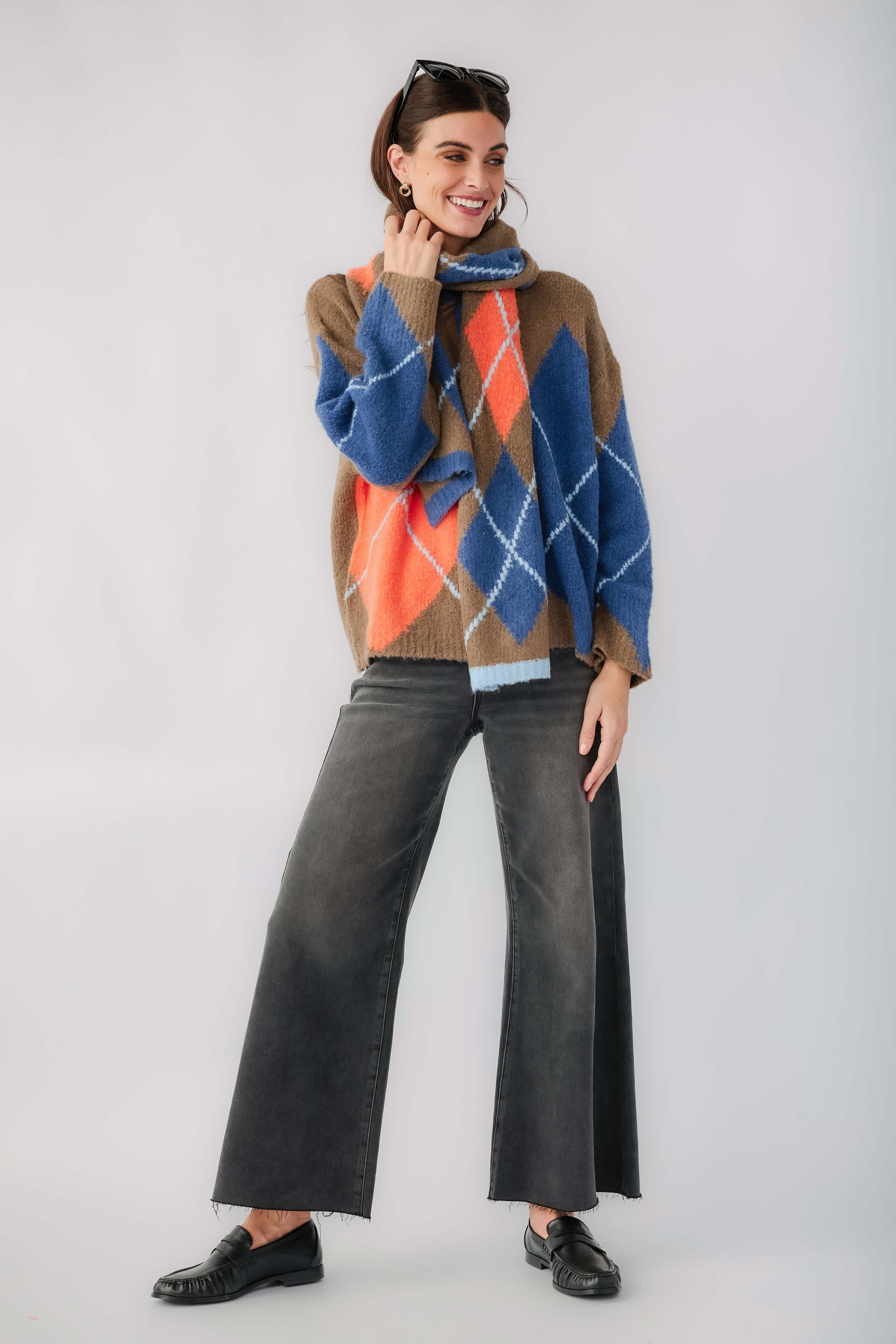 Kaki argyle cardigan with long sleeves and button front, blue and orange diamond pattern.