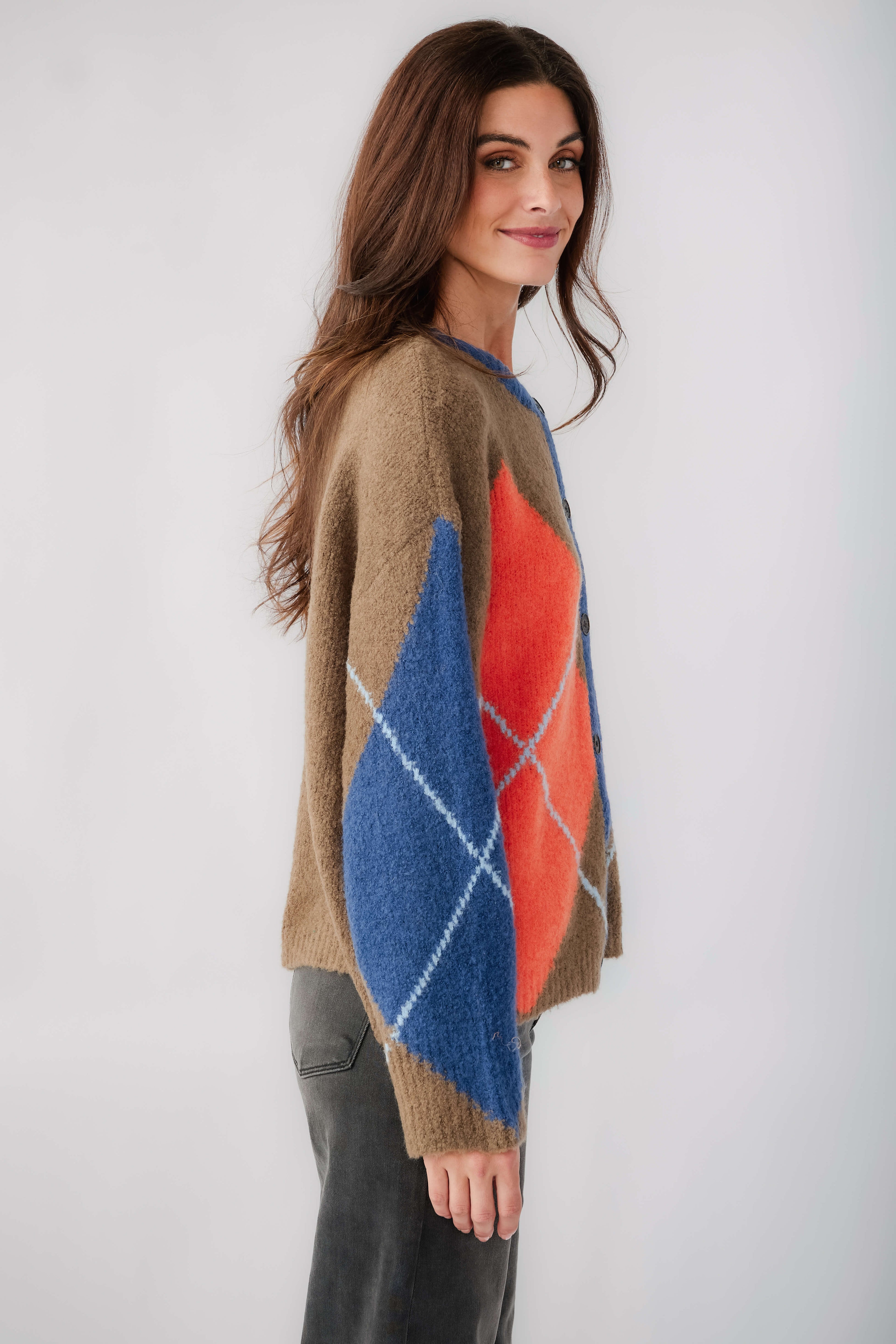 Kaki argyle cardigan, side view with button front and blue and orange diamond design.