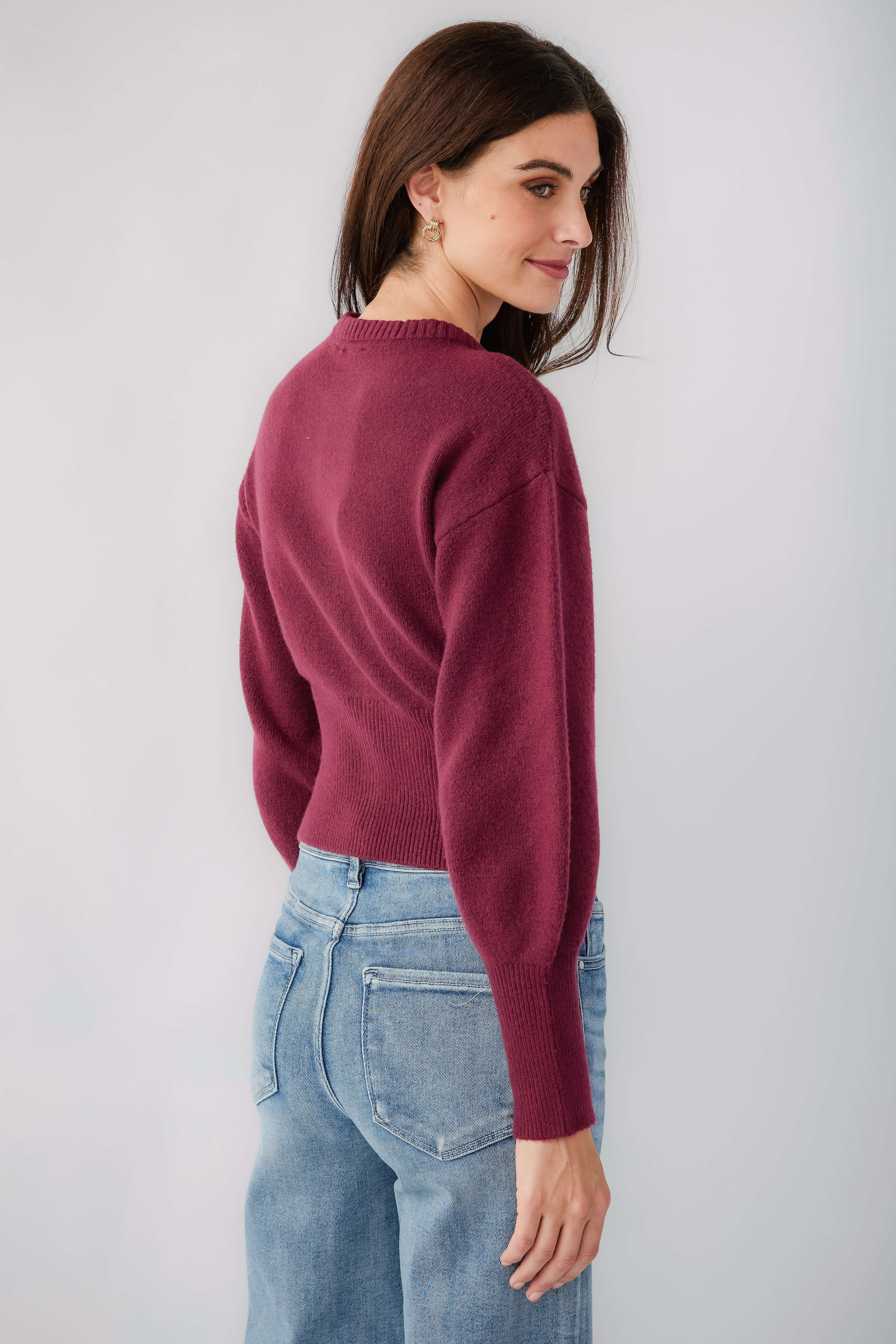 Burgundy crew-neck button cardigan with long sleeves, back/side view