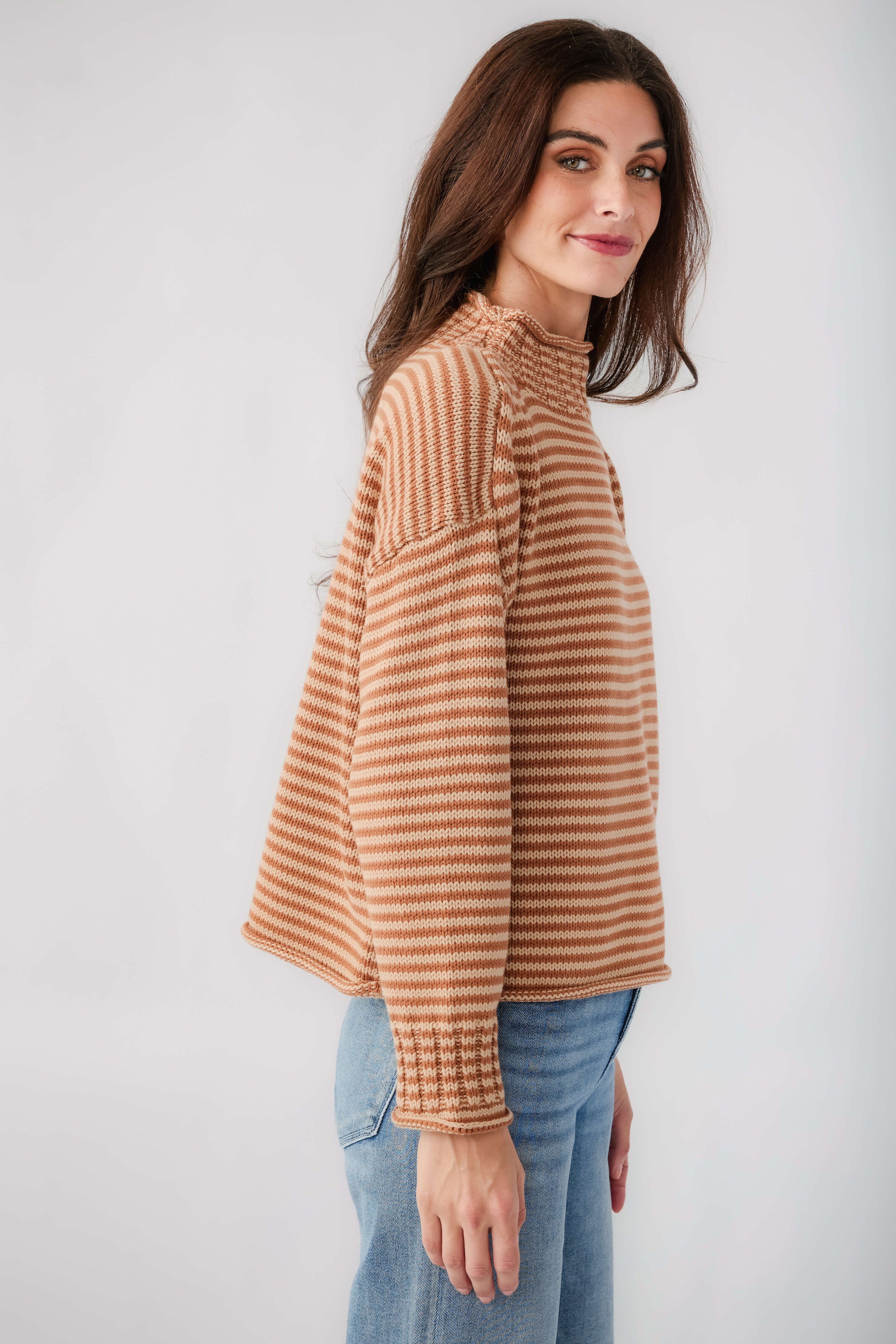 Orange-and-cream striped funnel neck long-sleeve sweater, side view