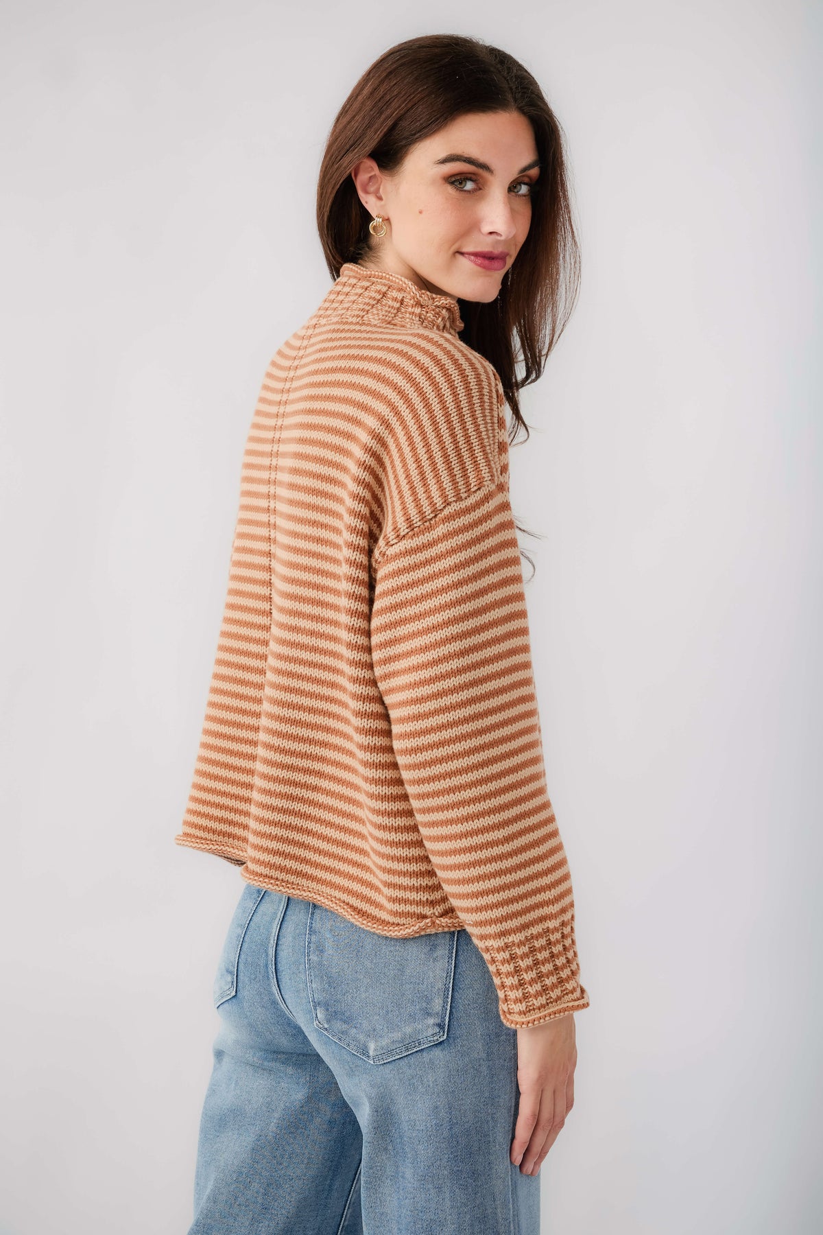 Orange-and-cream striped long-sleeve funnel neck sweater, angled view