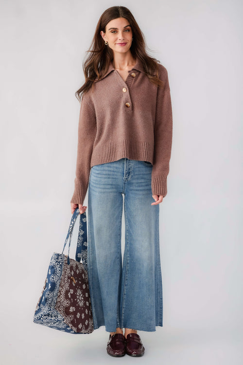 Brown knit polo sweater with button placket and turn-down collar, worn with light-wash jeans