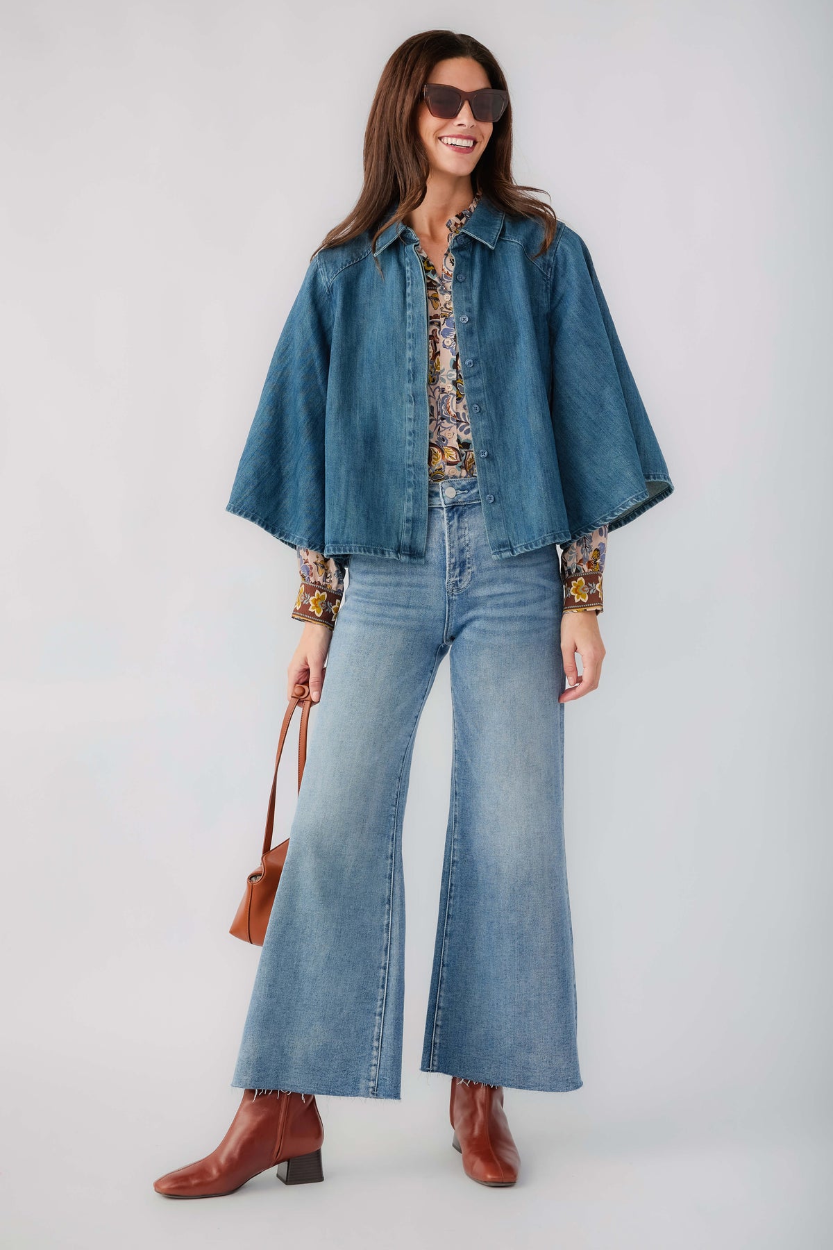 Medium blue wide-leg denim jeans with raw hem and front button closure