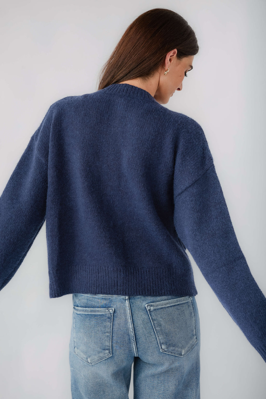Navy knit cardigan back view with ribbed hem and long sleeves