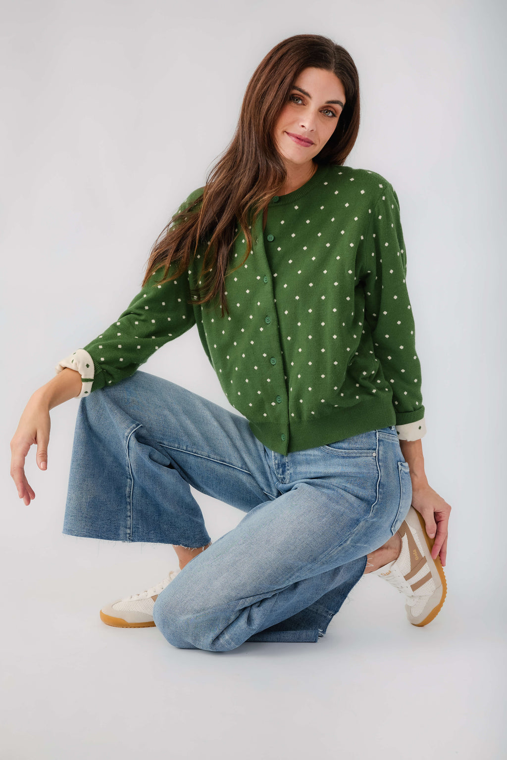 Green polka-dot cardigan with button front, cuffs, and long sleeves