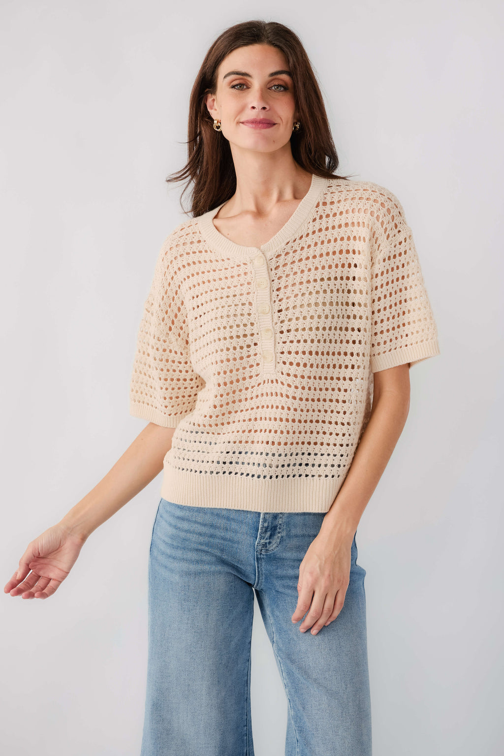 Cream open-knit polo sweater with button front and short sleeves, relaxed fit