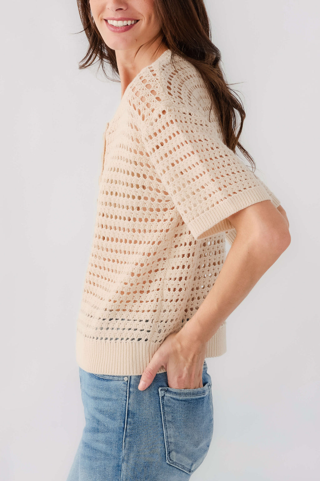 Cream open-knit polo sweater with short sleeves and button placket, side view