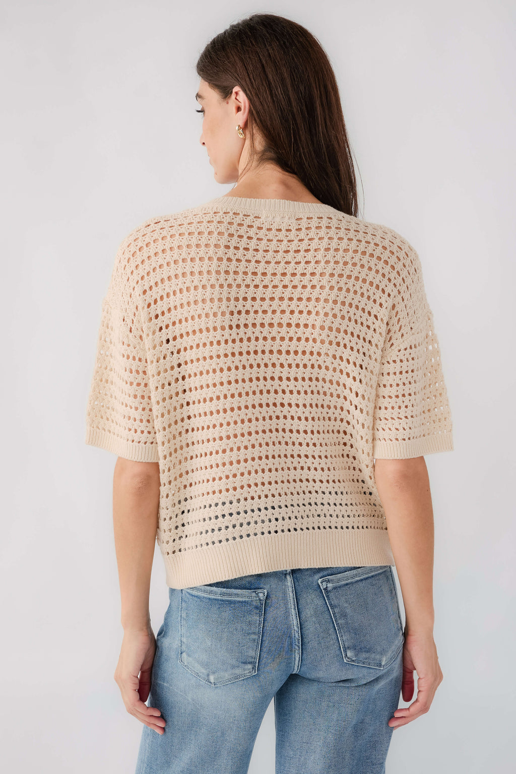 Cream open-knit polo sweater with short sleeves, back view with curved hem