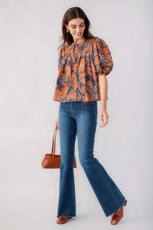 Rust-and-navy floral puff-sleeve blouse with flared hem and gathered neckline