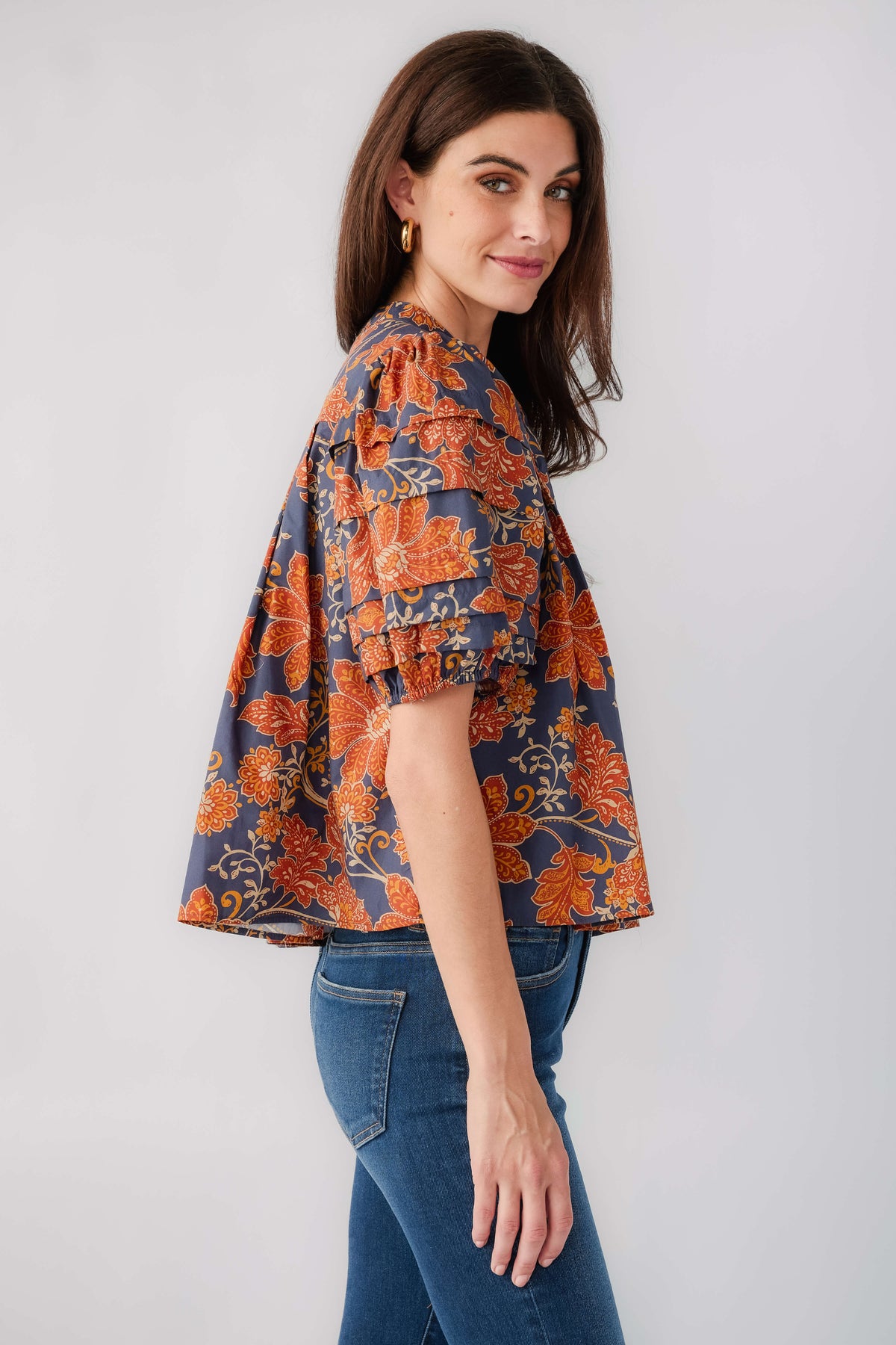 Rust and navy floral puff-sleeve top with flared hem and loose gathered fit