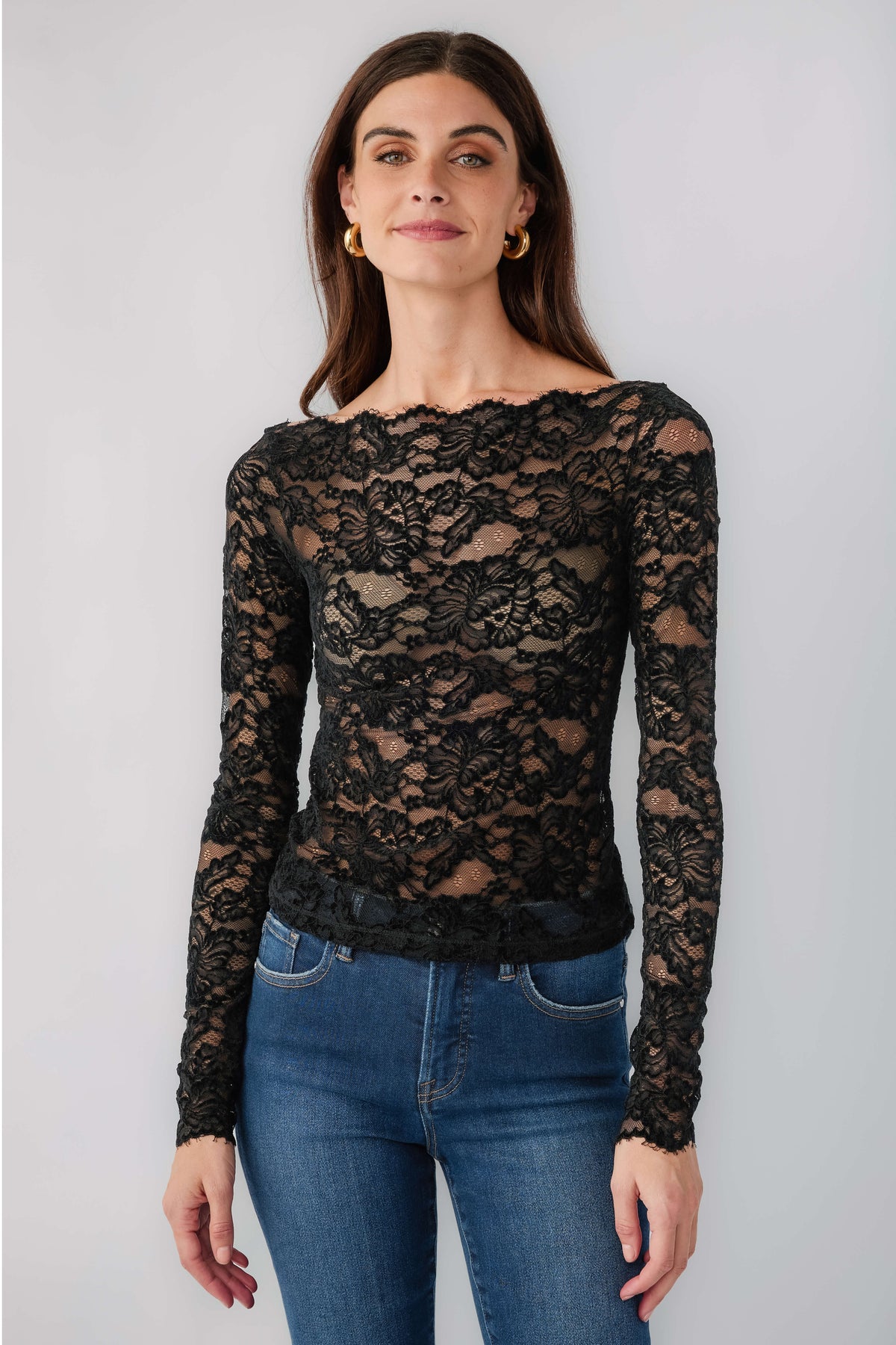Black lace long-sleeve top with scalloped crew neckline, fitted with floral motif pattern
